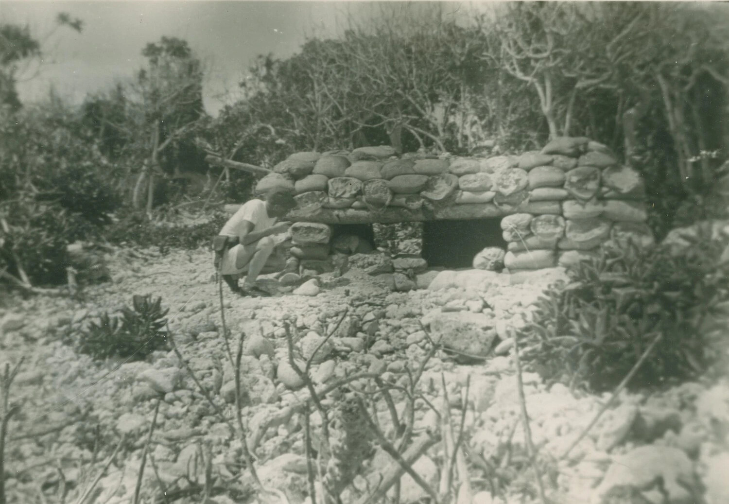 Serviceman Inspecting a Coral-and-Sandbag Bunker on a Pacific Island, WWII