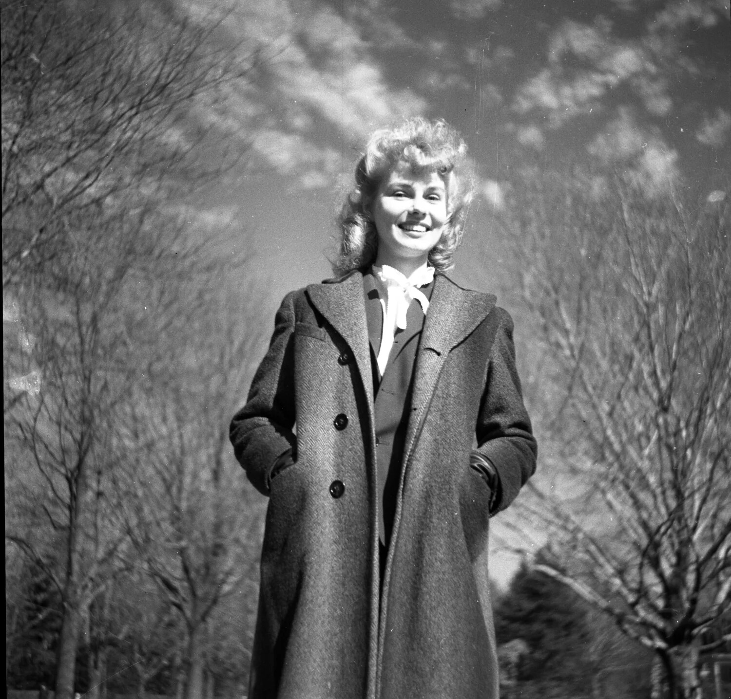 Young Woman Smiling Outdoors in Herringbone Wool Coat - Park Portrait