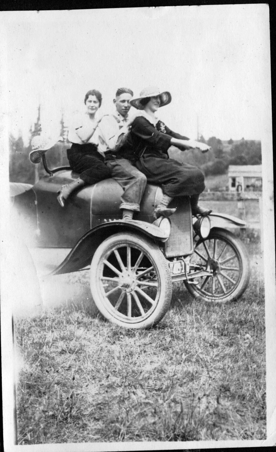 Three Young Adults Posed on a Model T Automobile, circa 1918-1922