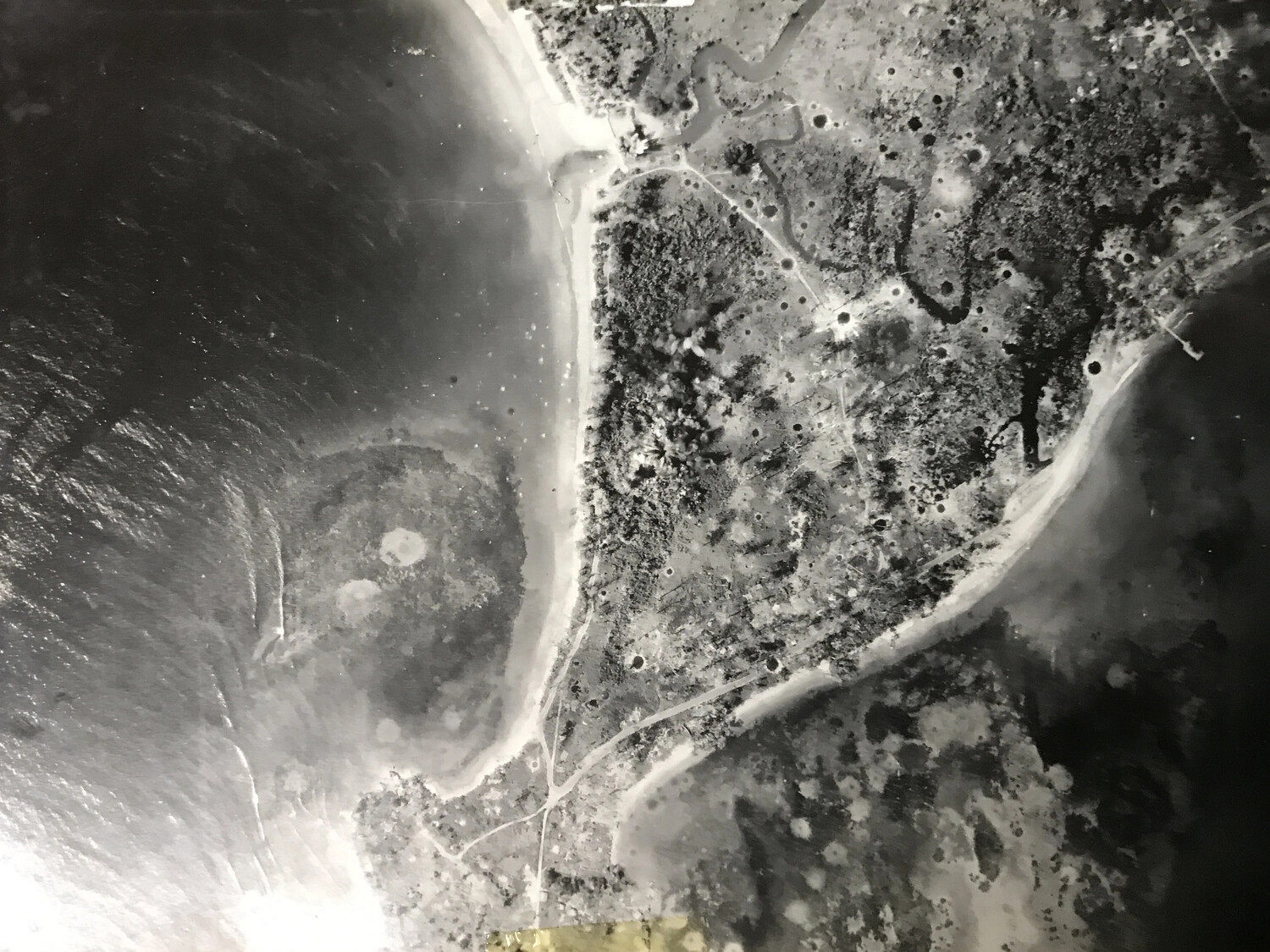 Vertical Aerial Photograph of Bomb-Cratered Peninsula, New Guinea Coast (Alternate Print)