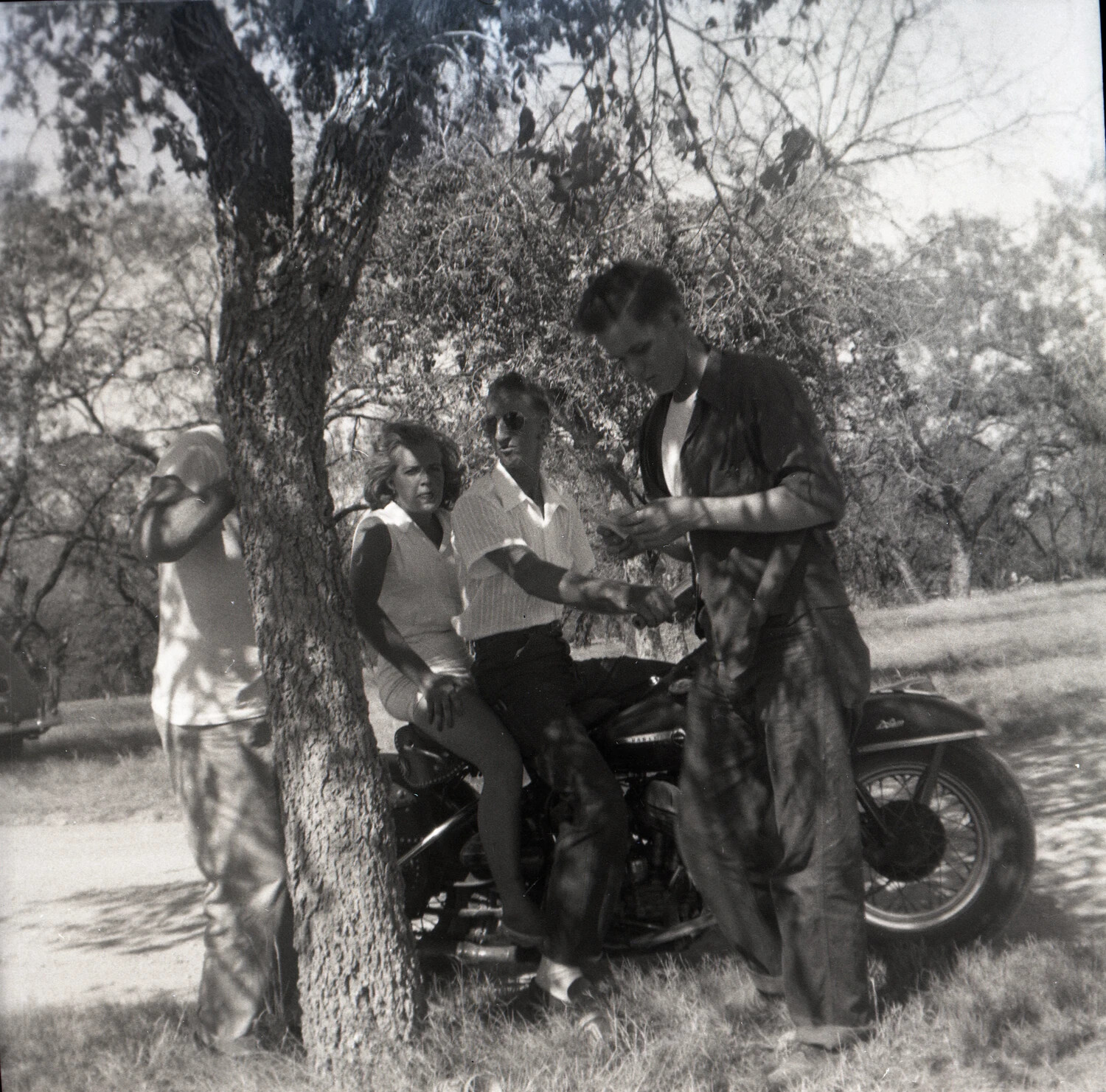 Group of Young Adults with Harley-Davidson Motorcycle, Outdoor Gathering