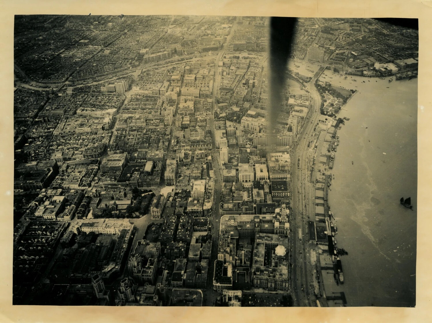 Aerial Reconnaissance Photograph of a Chinese Riverside City, Likely Shanghai, World War II Era