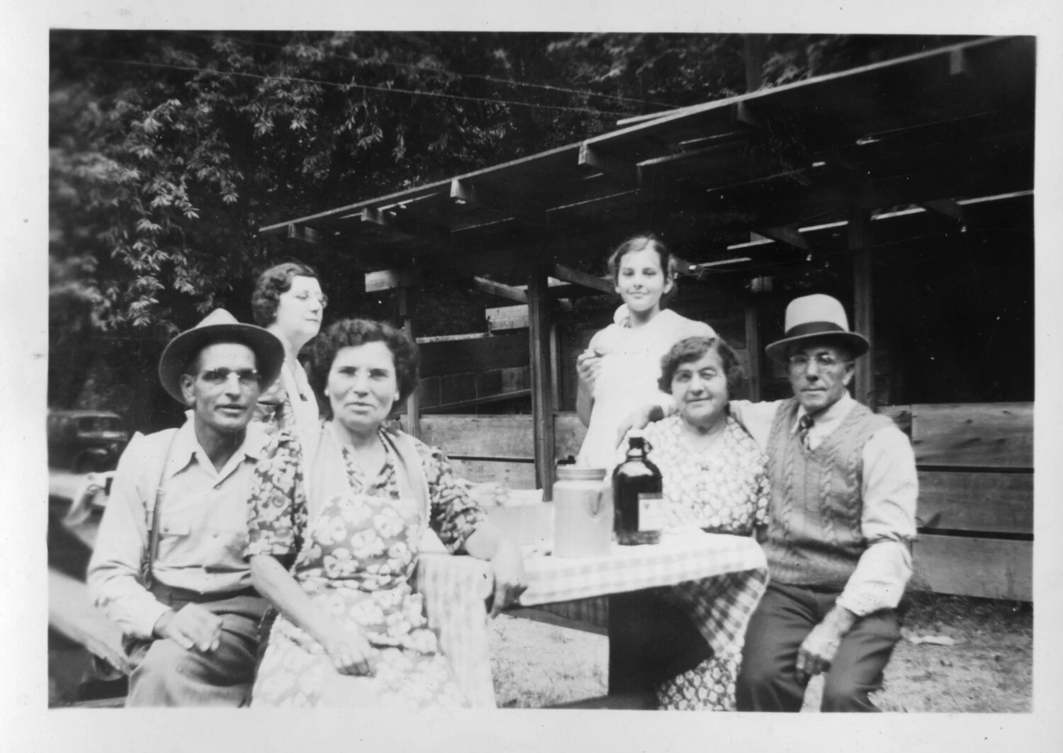 Family Gathering at an Outdoor Table Near a Barn, Presidio Album, c. 1930s