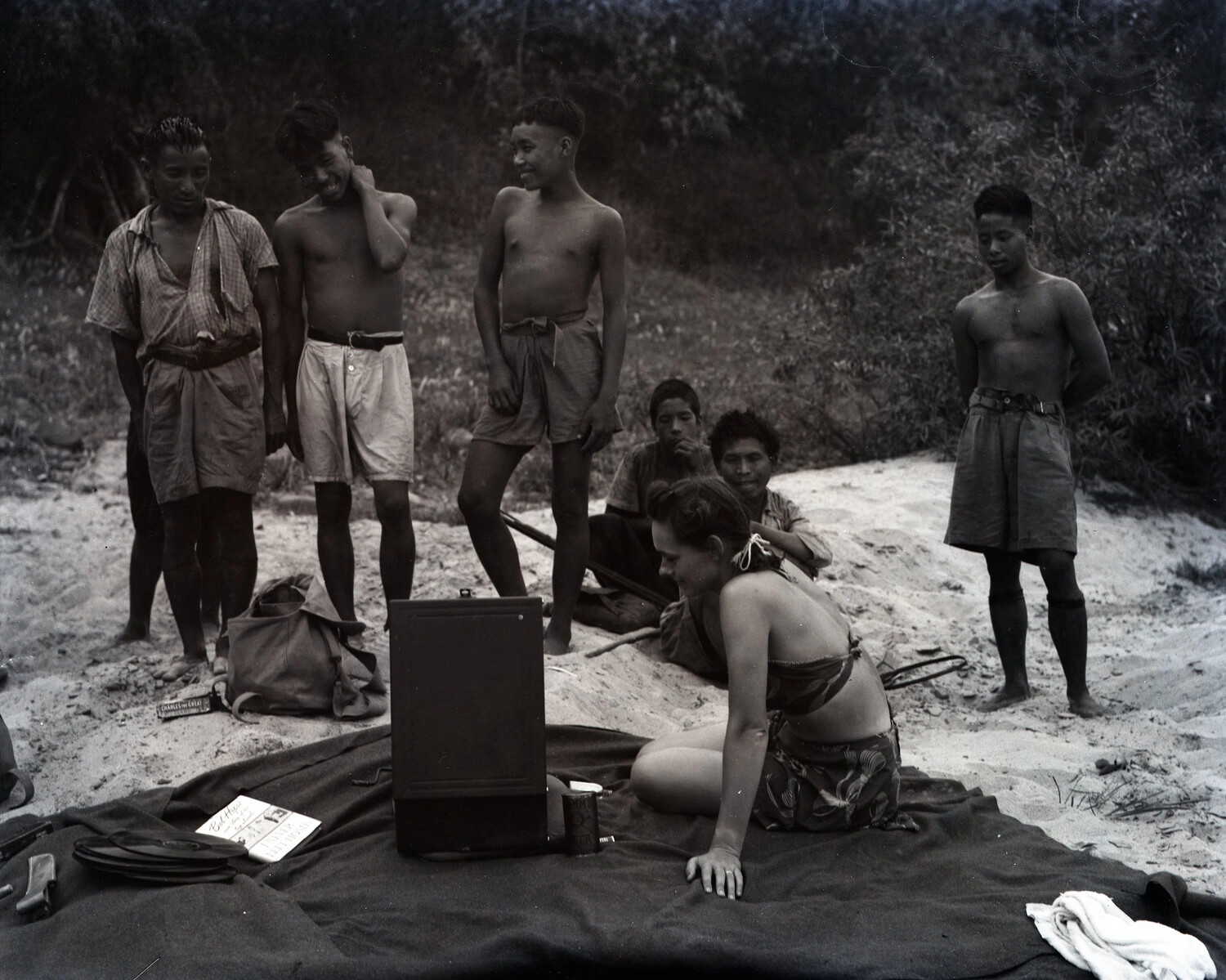 Woman with Portable Phonograph and Local Onlookers on Riverbank, WWII Burma-China Theater Collection (Myitkyina Area)