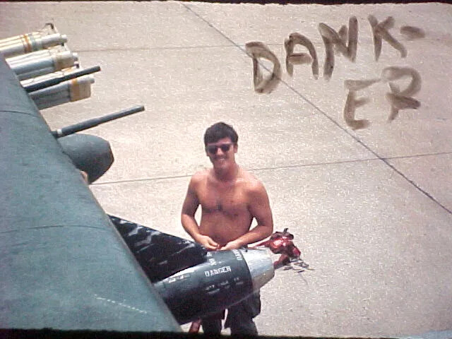 Serviceman Posing with Aircraft Ordnance on Ramp, Da Nang Air Base, South Vietnam