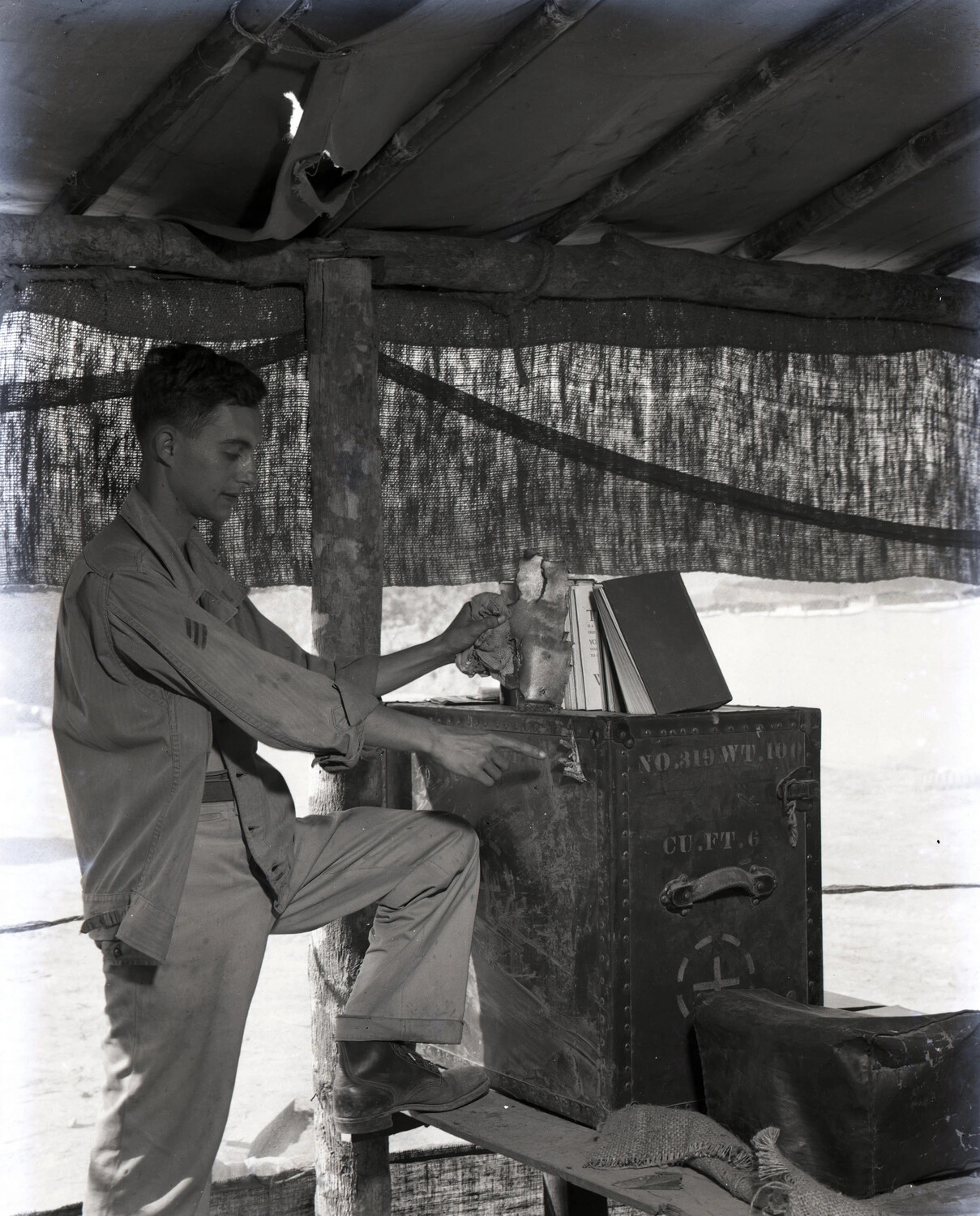 Serviceman with Personal Effects atop Squadron Shipping Trunk, CBI Theater, WWII (KOTEC Collection)