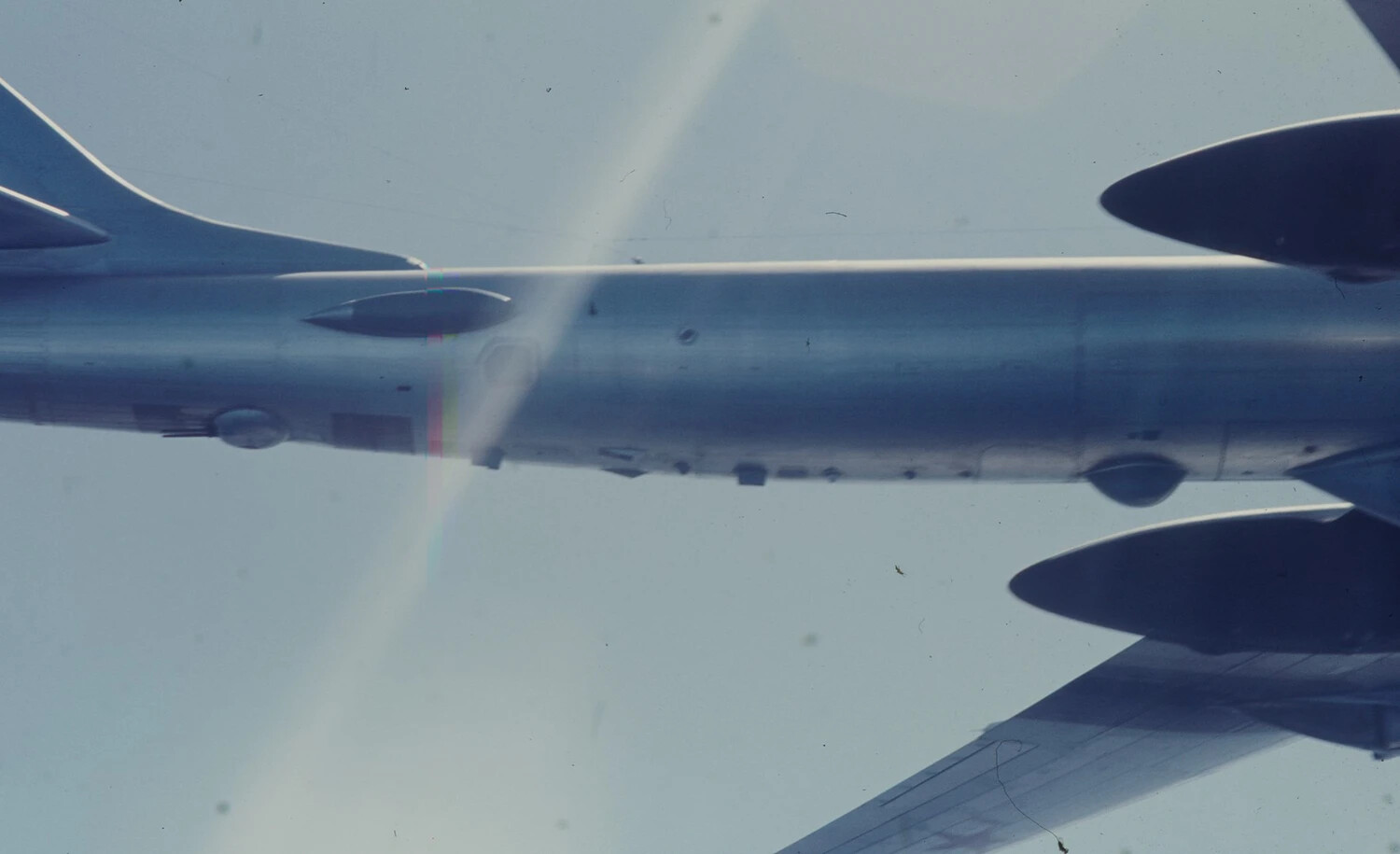 Backlit Air-to-Air Photograph of Multi-Engine Support Aircraft, Vietnam War Era