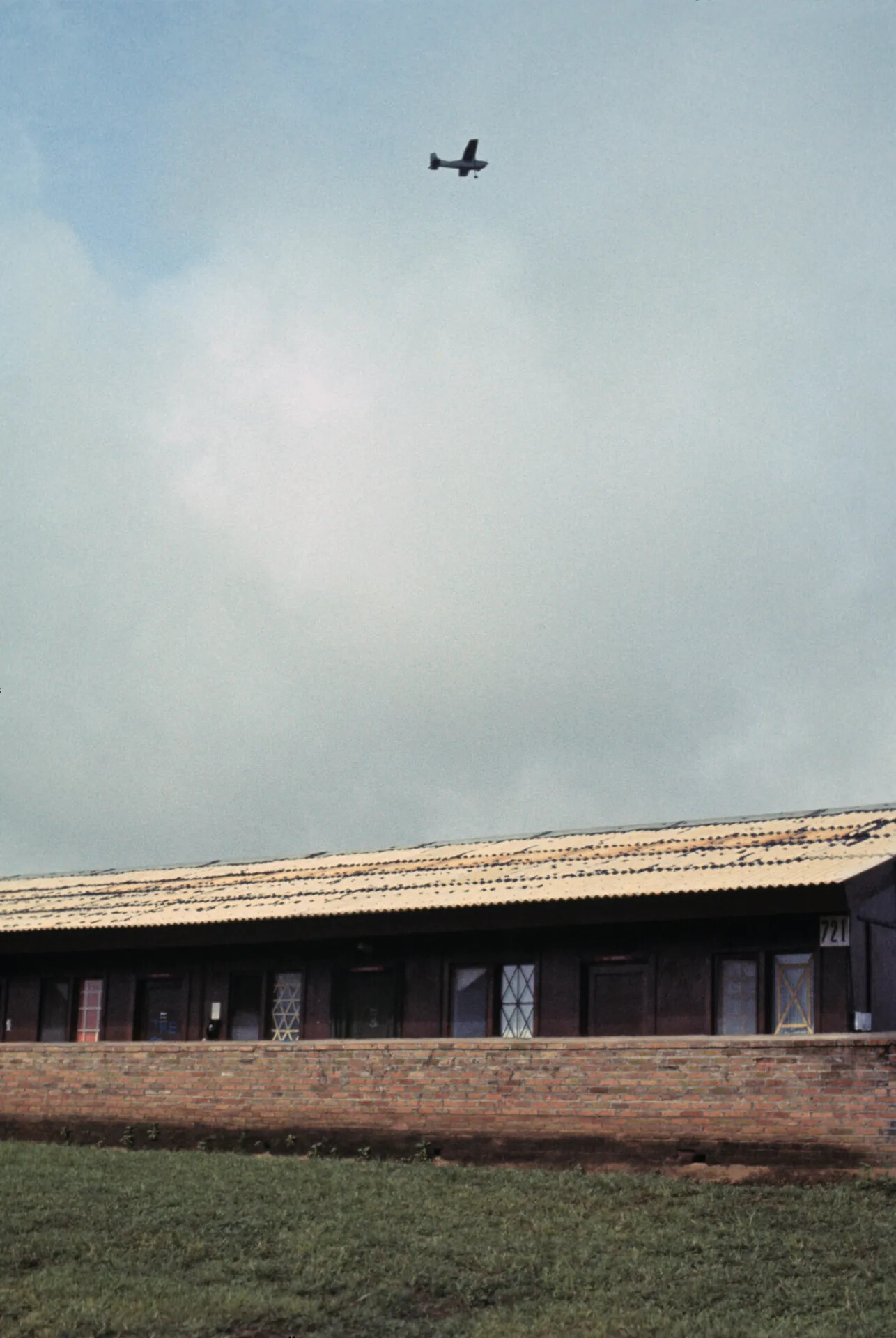 Light Observation Aircraft Overflying Barracks Building 721 — Don Engebretsen Slide Collection