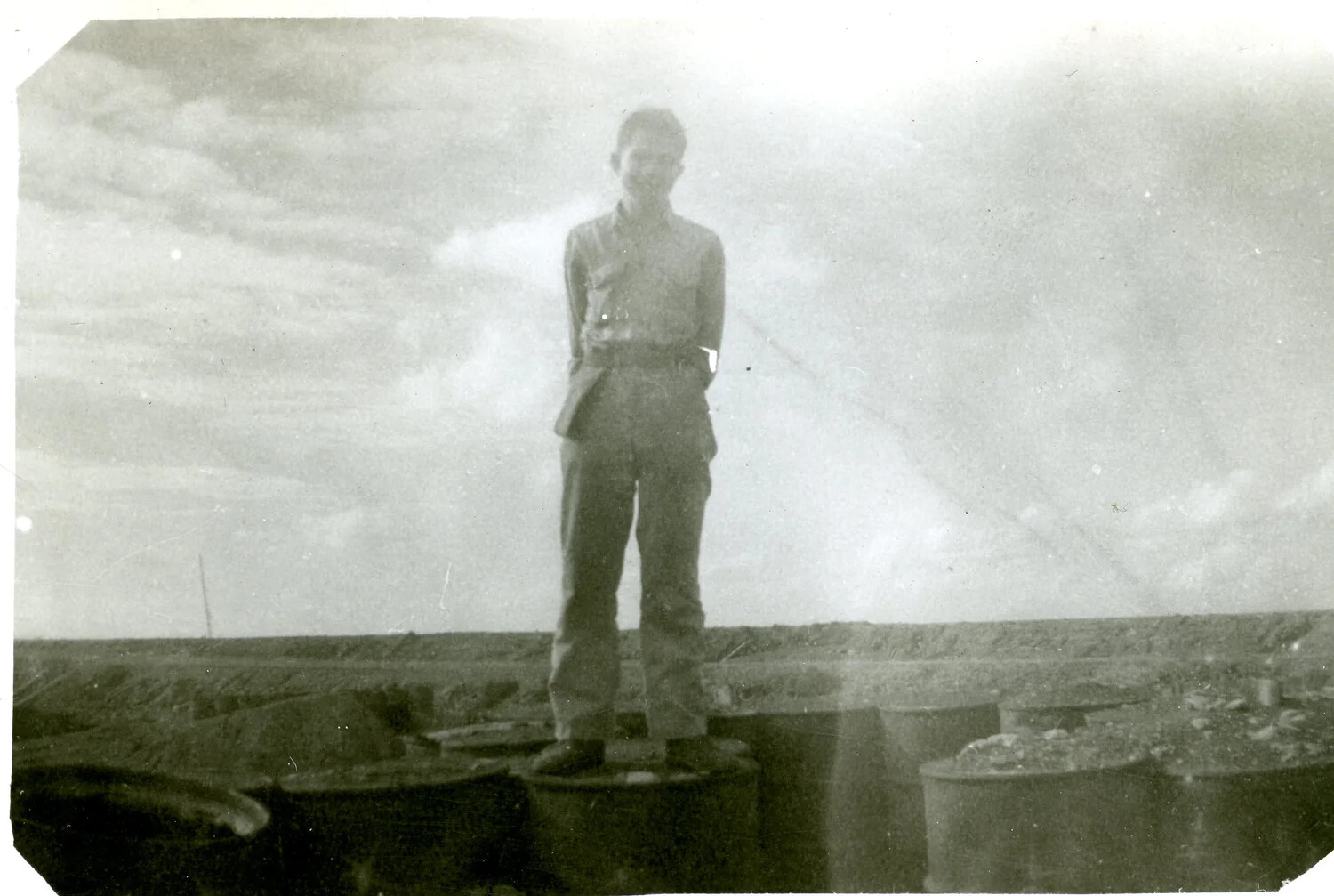 Marine Standing on Fuel Drums, Iwo Jima, 5th Marine Division, WWII