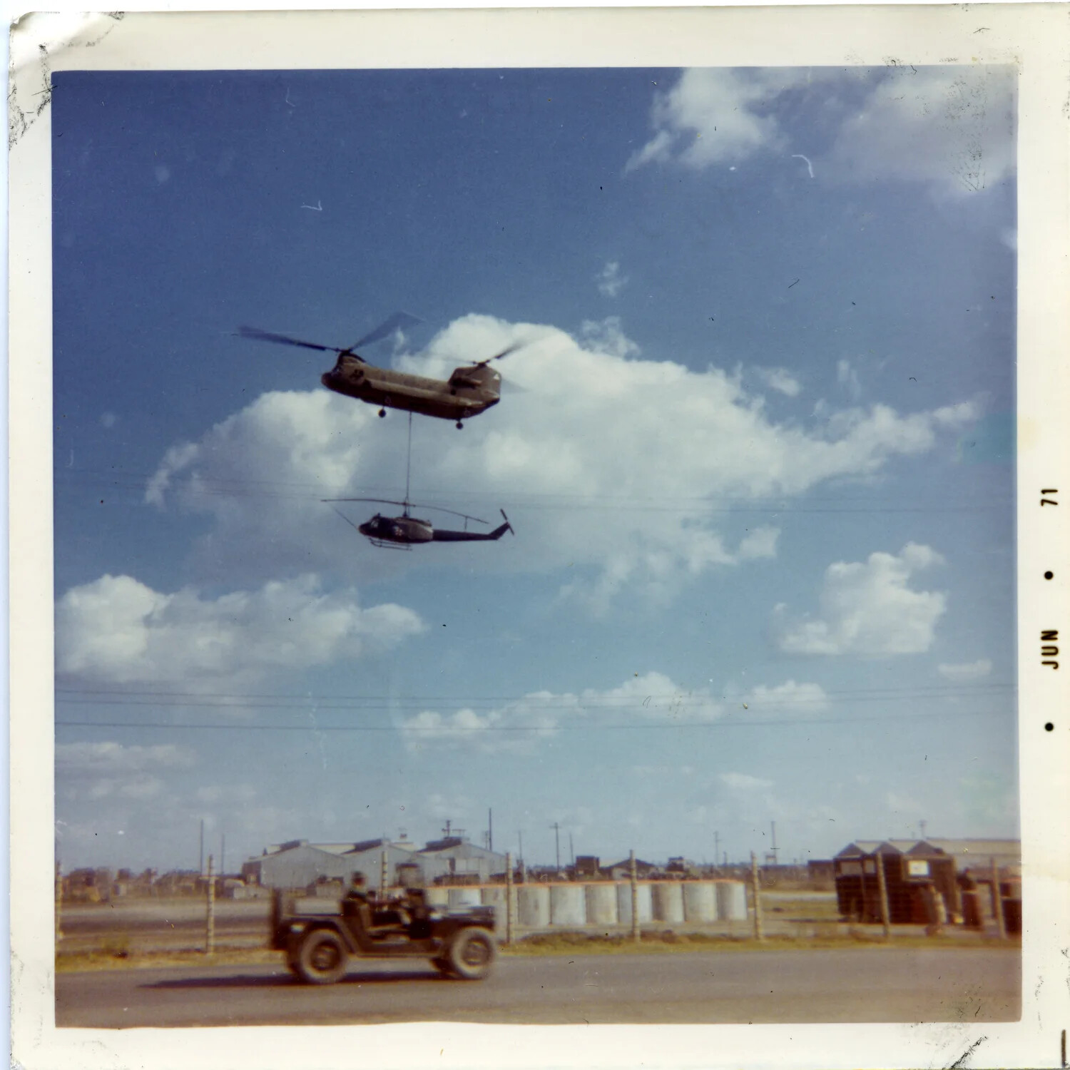 CH-47 Chinook Airlifting UH-1 Huey Helicopter by Sling Load, South Vietnam, June 1971