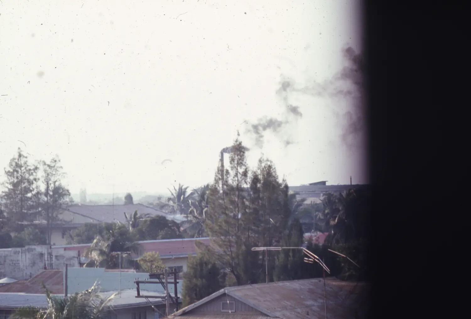 Rooftop View of a Vietnamese Port Town with Rising Smoke, Vietnam War Era