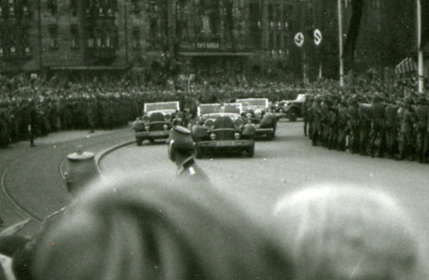 German State Motorcade Through Crowd-Lined City Street with Nazi Party Banners, WWII Era