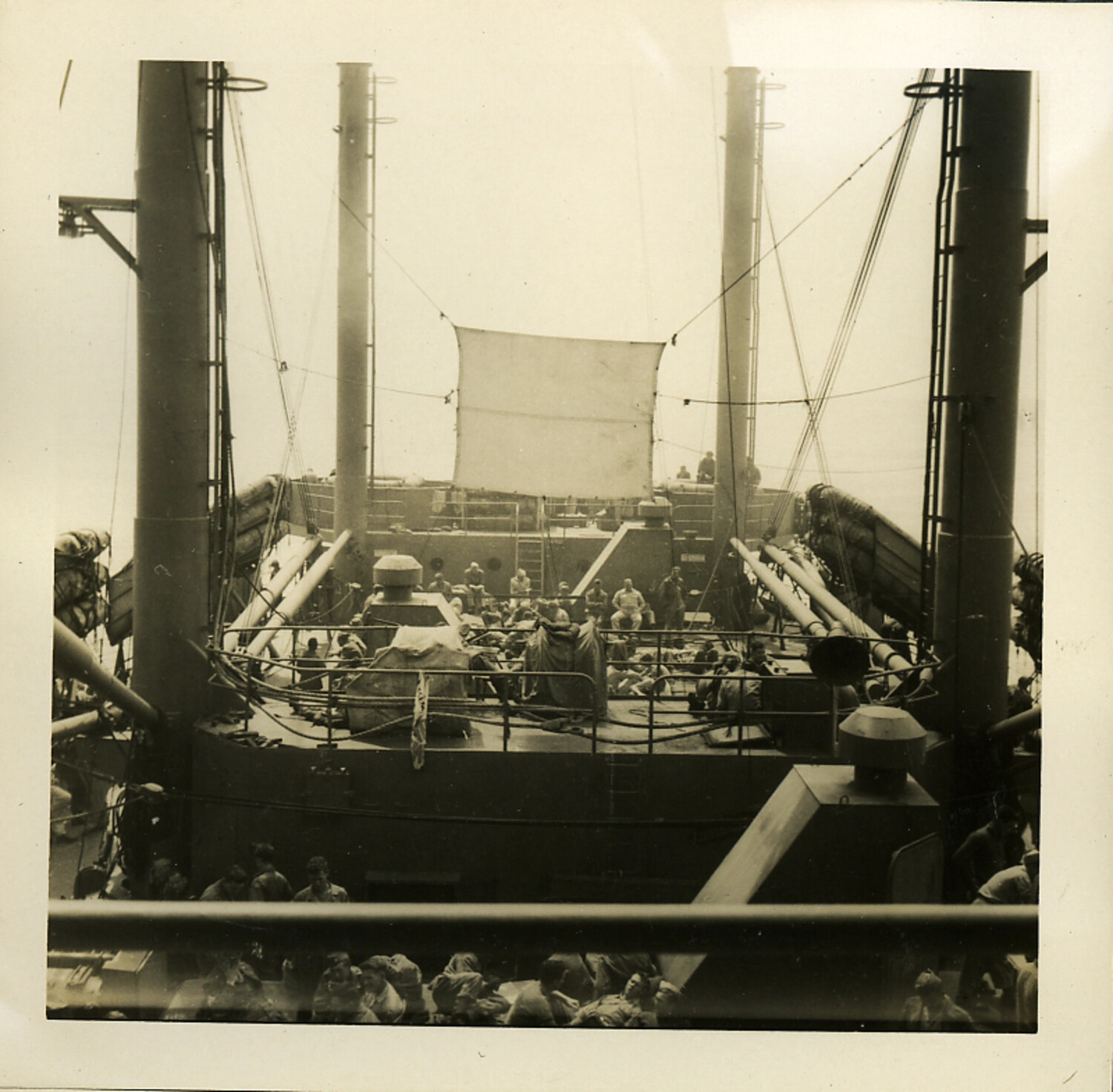 Servicemen Gathered on Forward Deck Beneath Rigged Screen, Troop Transport Ship, WWII/Postwar Era