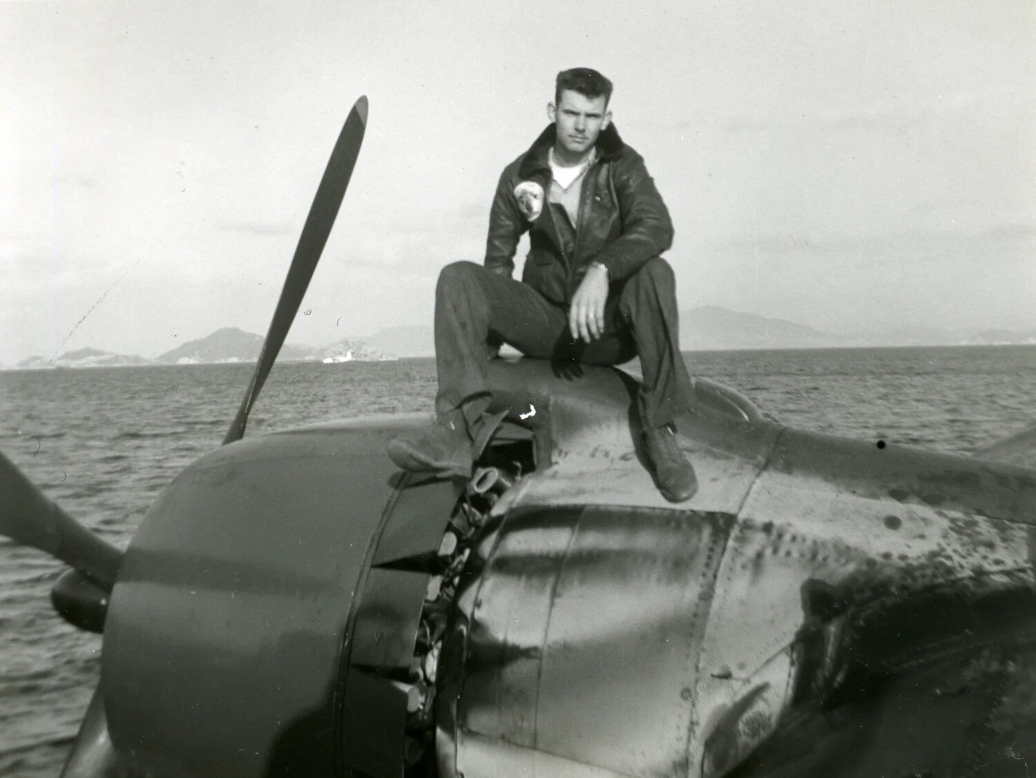 Aviator Seated on Damaged Radial-Engine Fighter Aircraft, Korean War Era (Joseph Smith / Lt. Bancroft Collection)