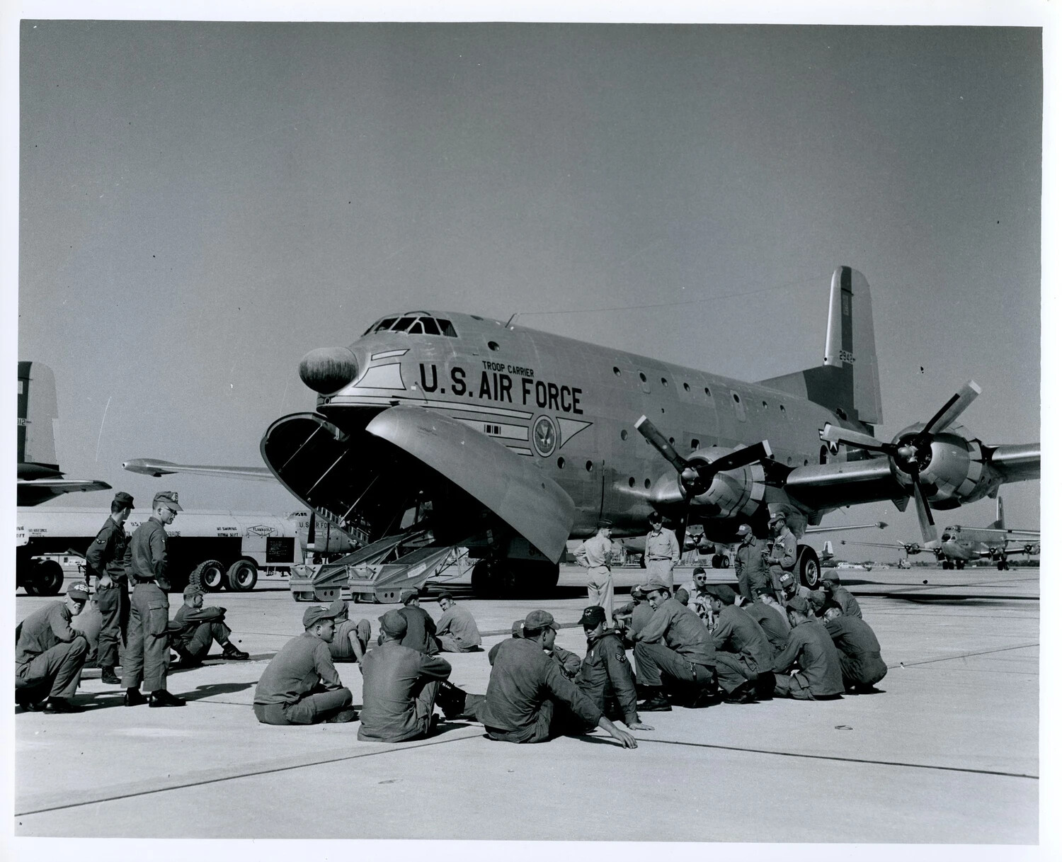 Douglas C-124 Globemaster II Troop Carrier with Assembled Airmen on Flight Line