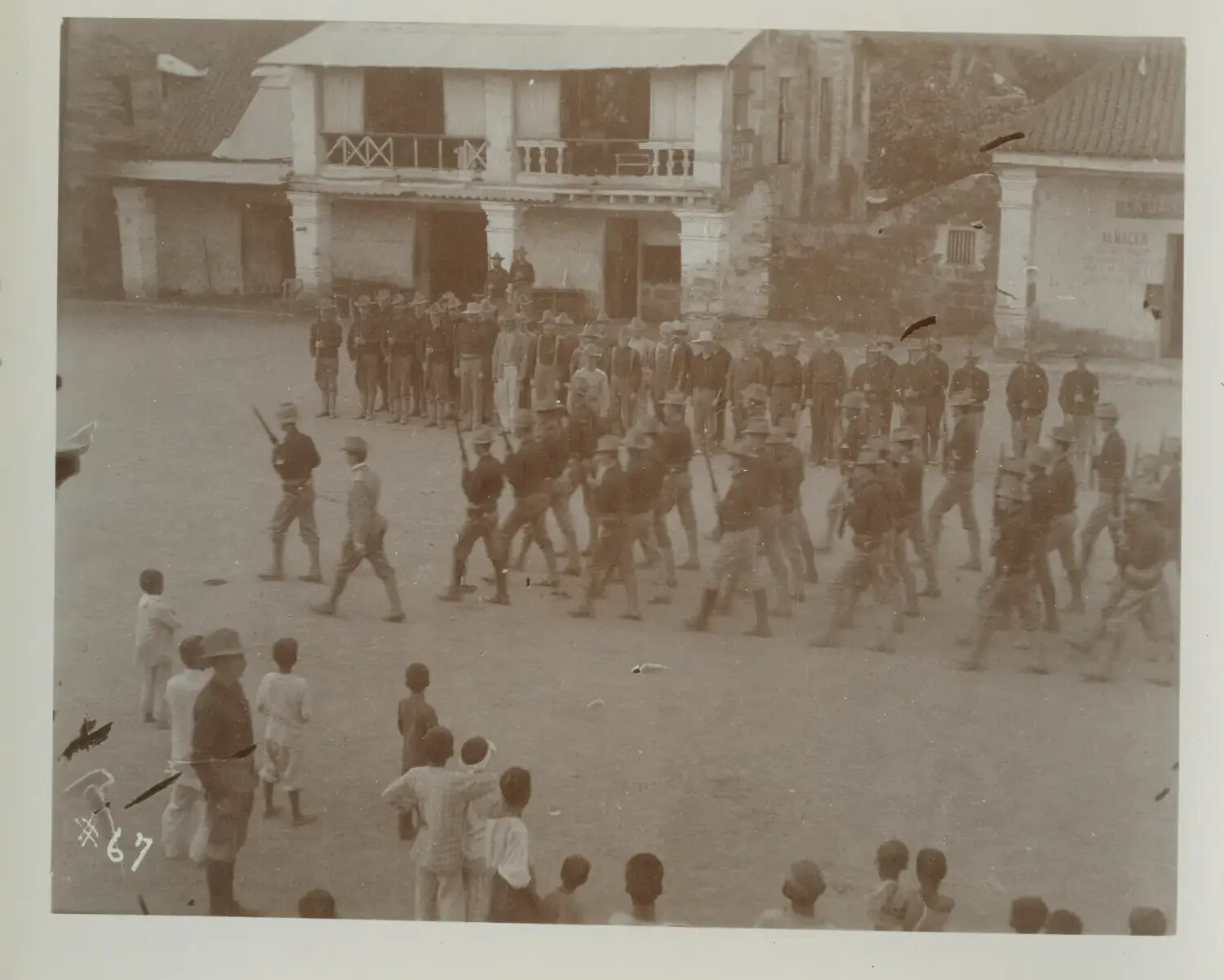 U.S. Soldiers Drilling in Town Plaza Before Local Spectators, Philippines, c. 1890s-1900s