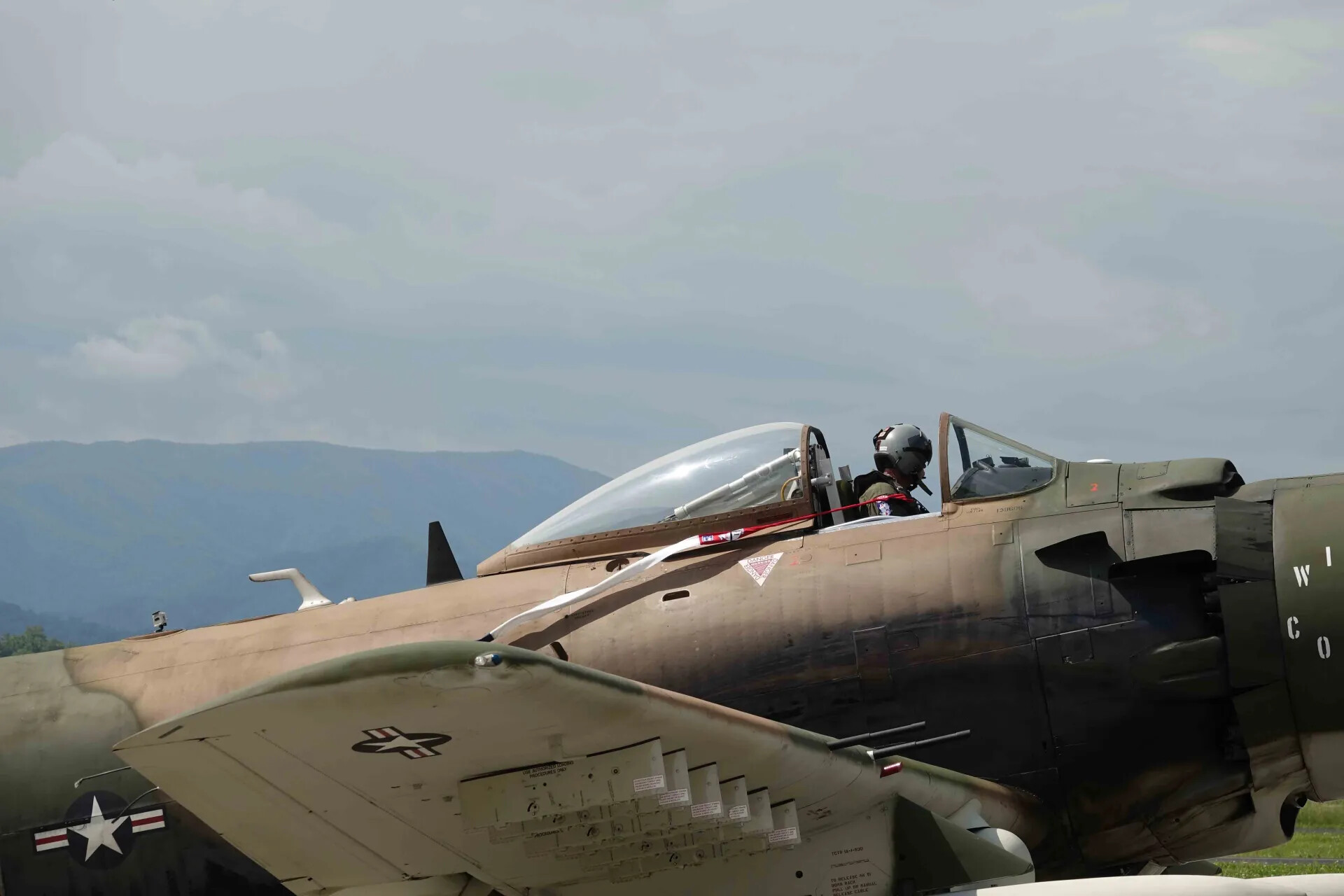 Pilot in Cockpit of Restored A-1 Skyraider with Second Skyraider in Foreground, Airshow, 2019