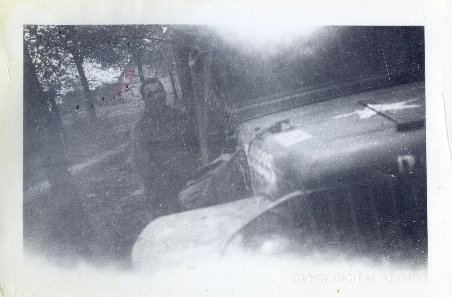 Overexposed Snapshot of Military Vehicle and Figure Along Tree-Lined Roadside, European Theater, WWII Era