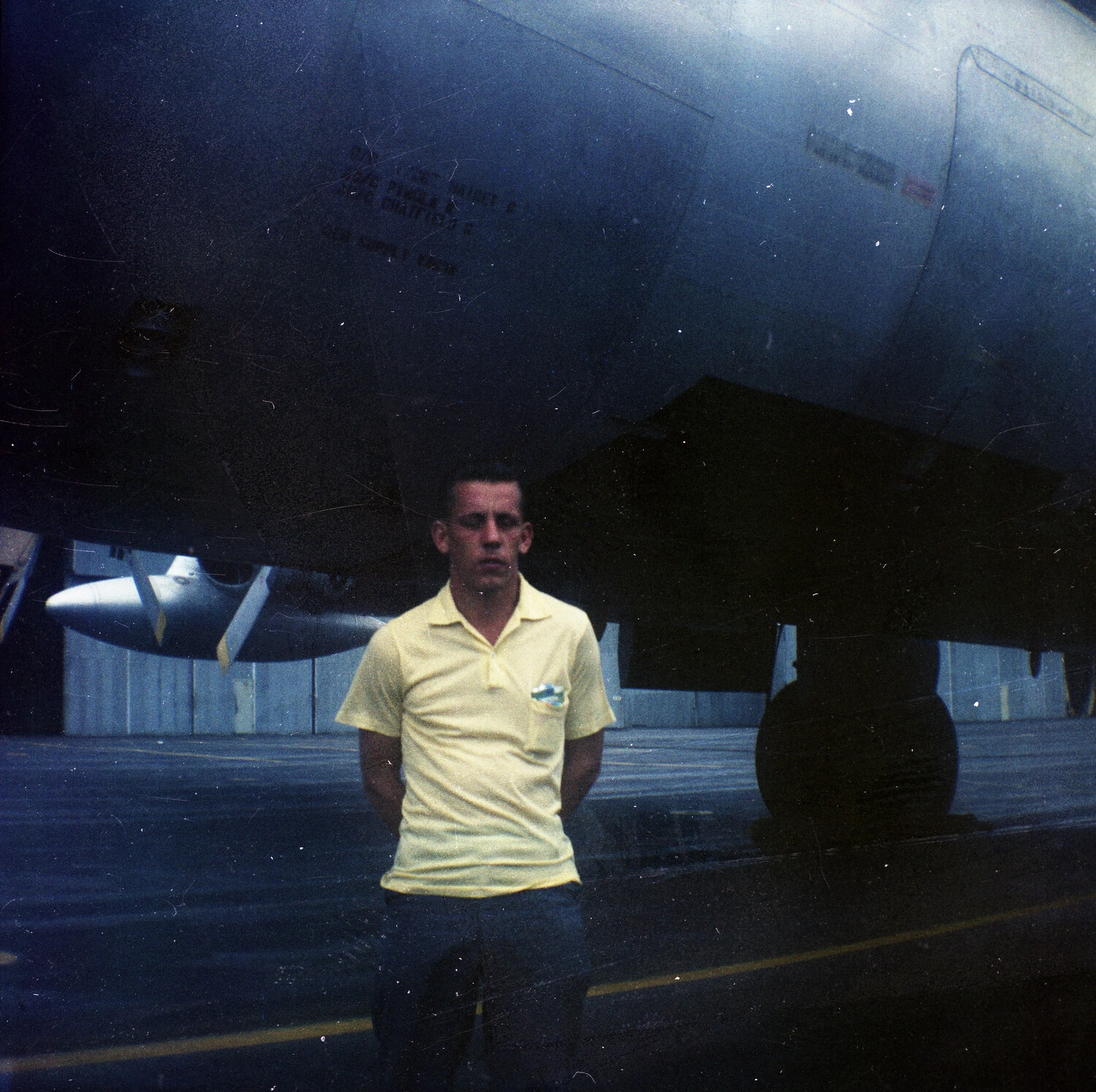 Airman Posed Beneath the Nose of His Boeing C-97 Stratofreighter