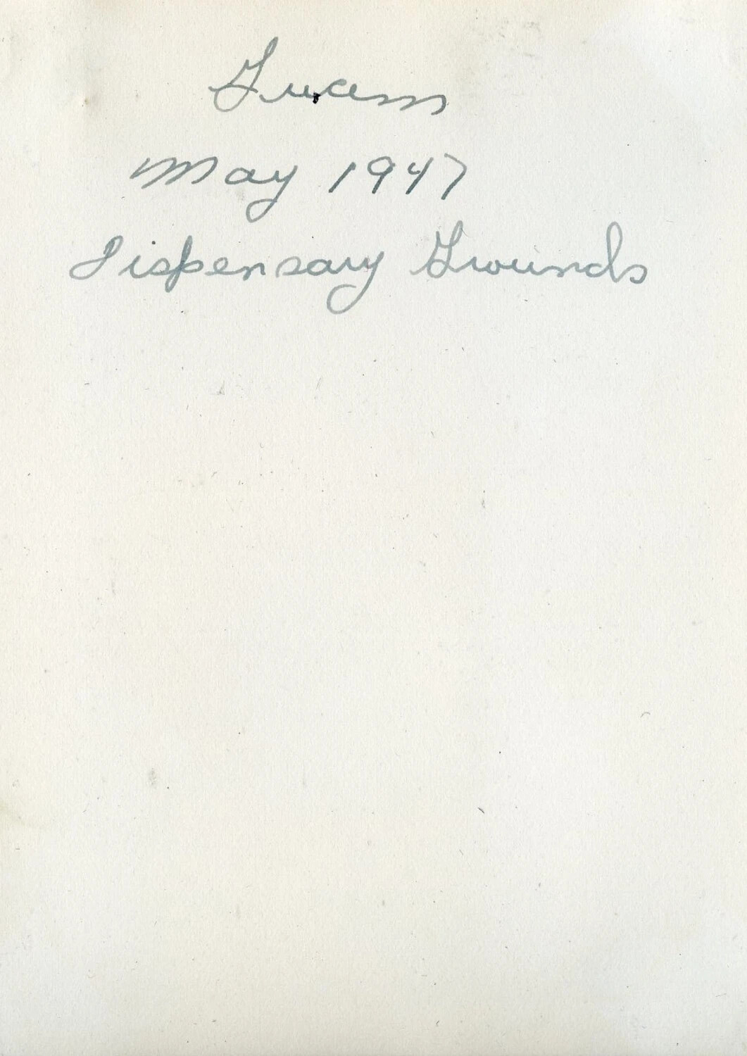 Photo Album Page with Handwritten Caption, 'Guam, May 1947, Dispensary Grounds'