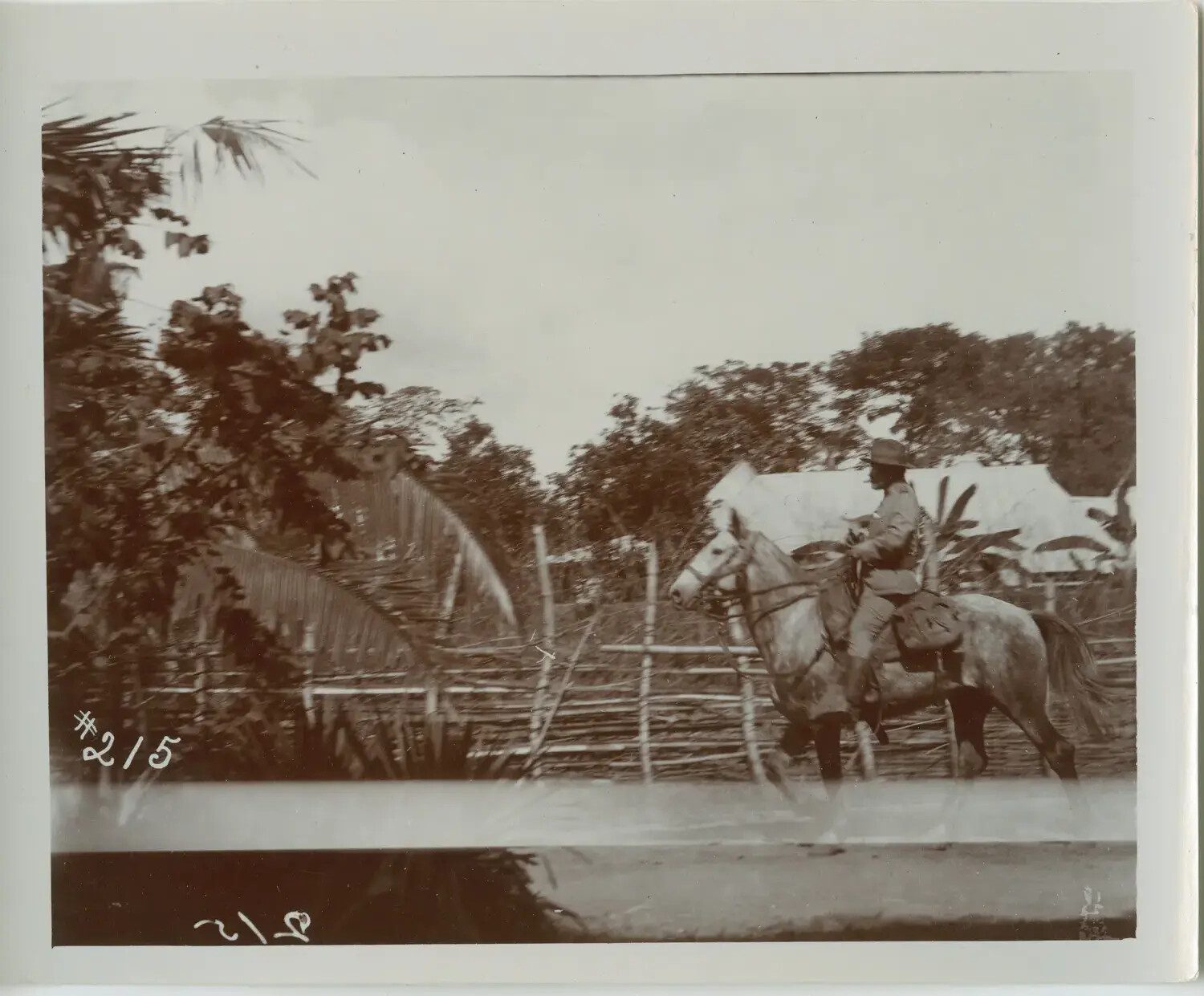 Mounted U.S. Cavalry Trooper Passing Camp Perimeter Fence, Philippines, Early 1900s
