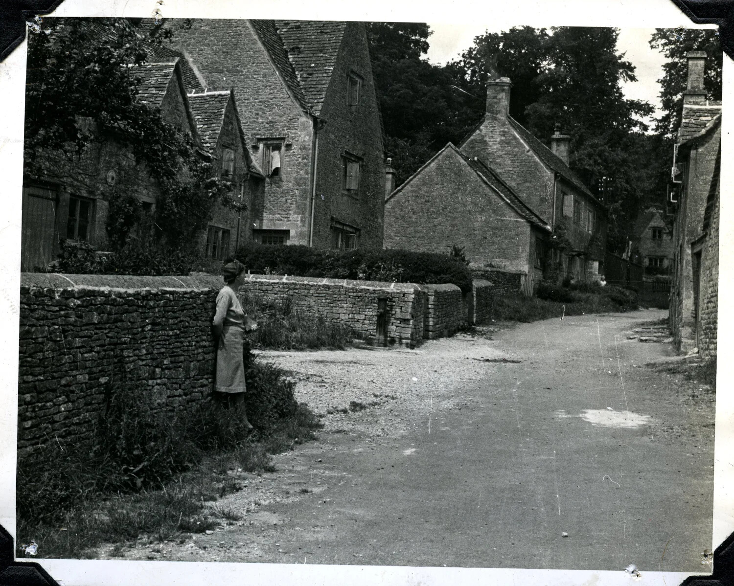 English Village Lane with Woman by Stone Wall, Cotswold-Style Cottages