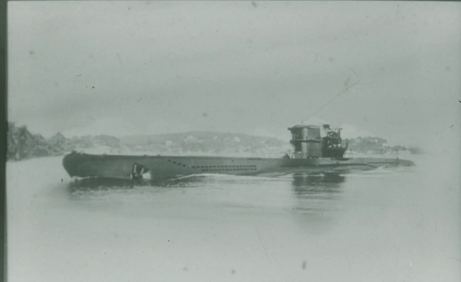 Surfaced World War II-Era Submarine (Likely German U-boat) Near Coastline