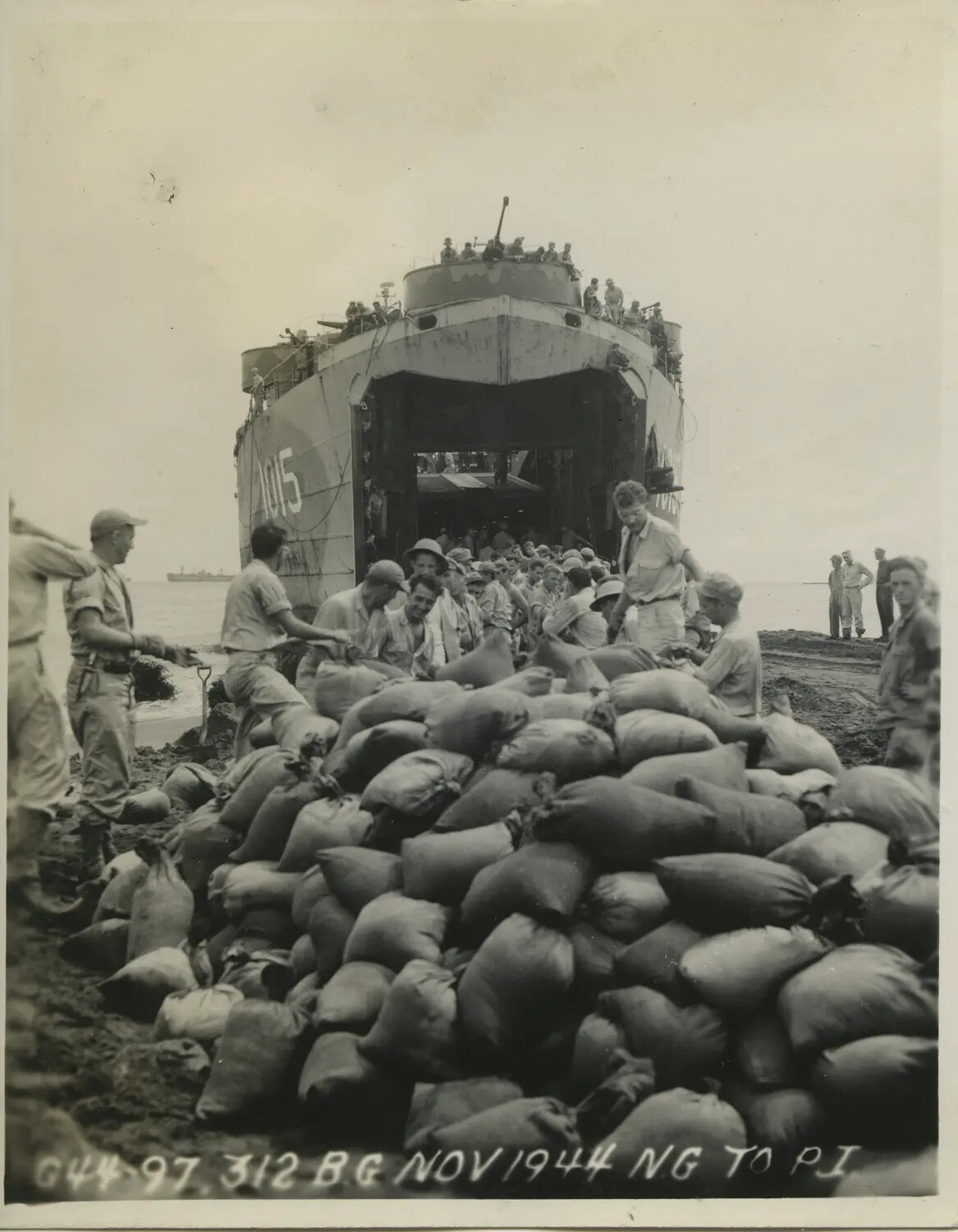 LST-1015 Unloading Troops and Sandbags, 312th Bombardment Group, November 1944