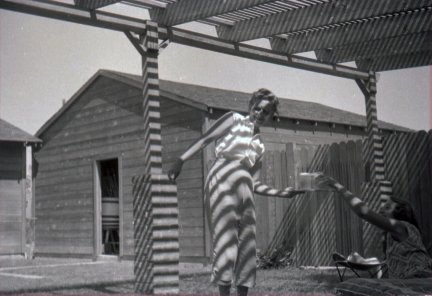 Backyard Snapshot Under a Pergola, 'Dixon, C.' — Personal Photo, USS Yorktown-Associated Collection