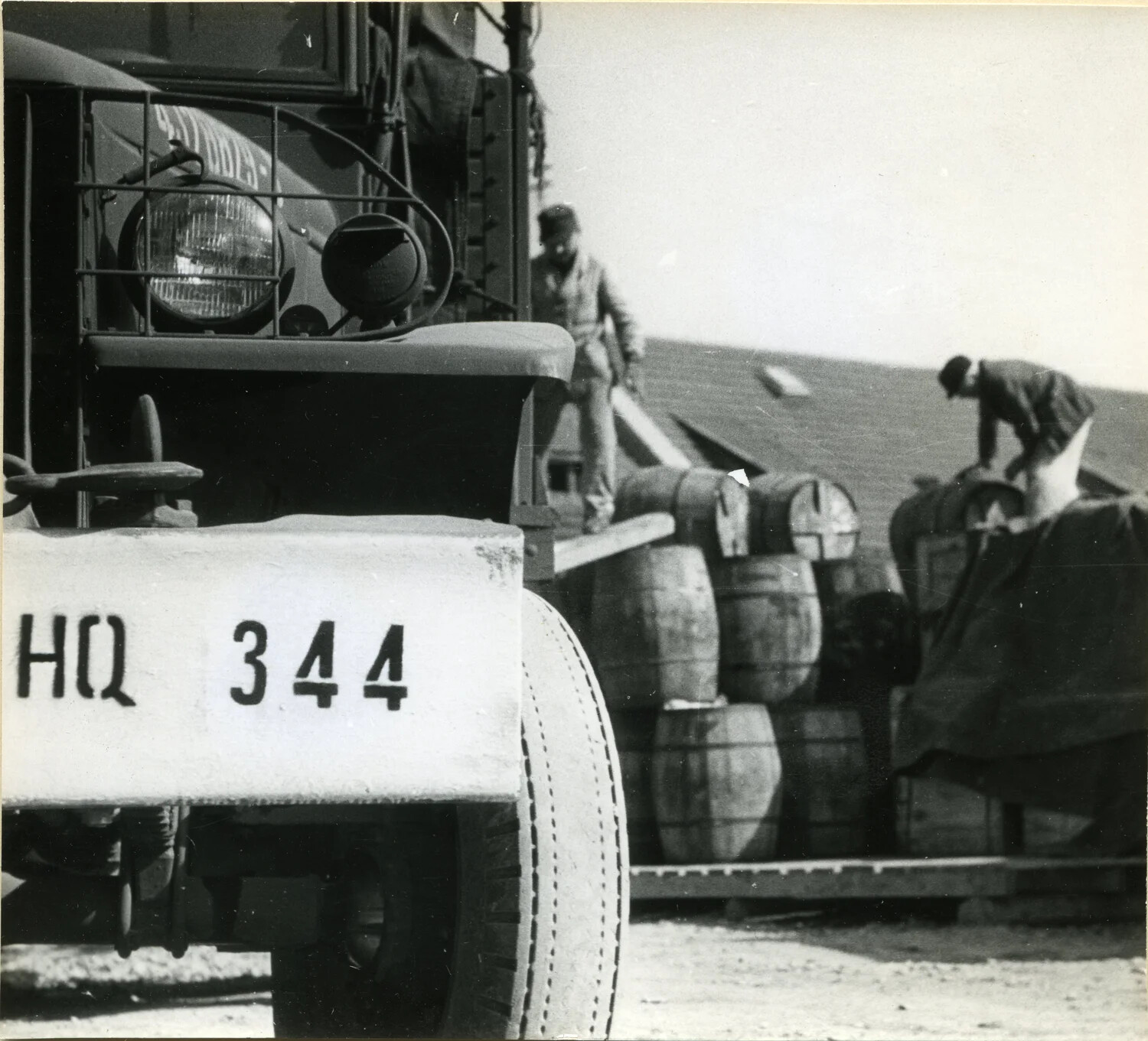 Close-Up Detail: Studebaker Cargo Truck "HQ 344" Unloading at a Germany Supply Depot