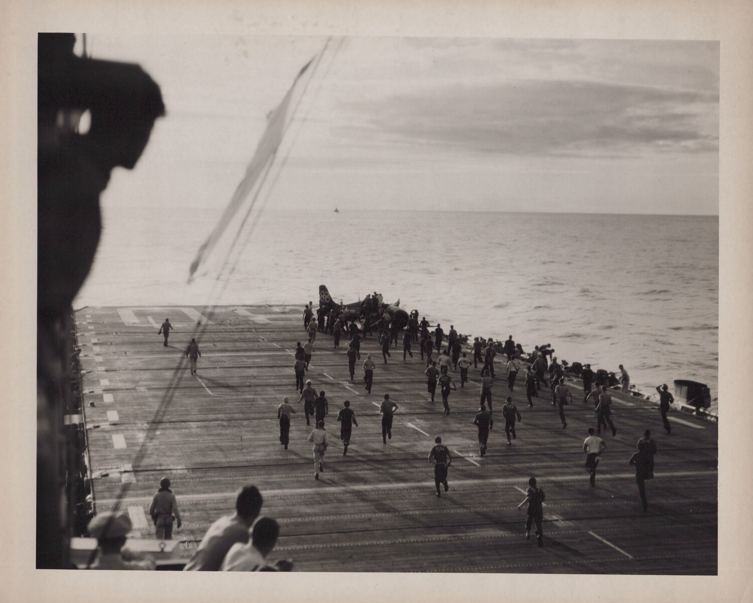 Flight Deck Crew Rushing to an Aircraft Aboard USS Petrof Bay (CVE-80), World War II
