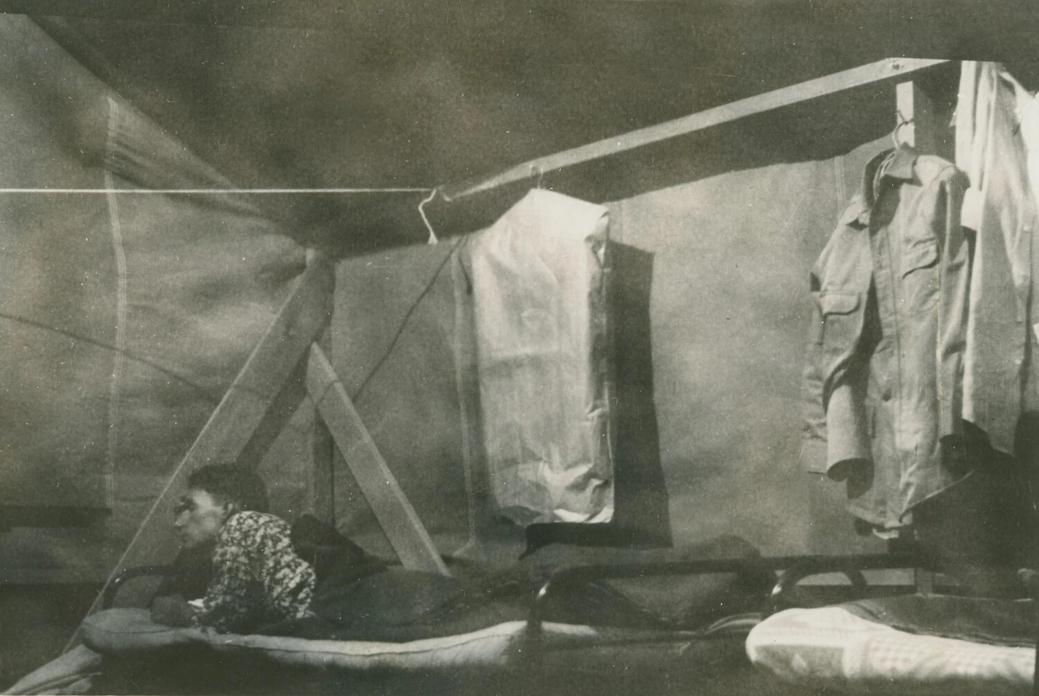 Tent Interior with Serviceman Resting and Hanging Uniforms, Pacific Theater, WWII