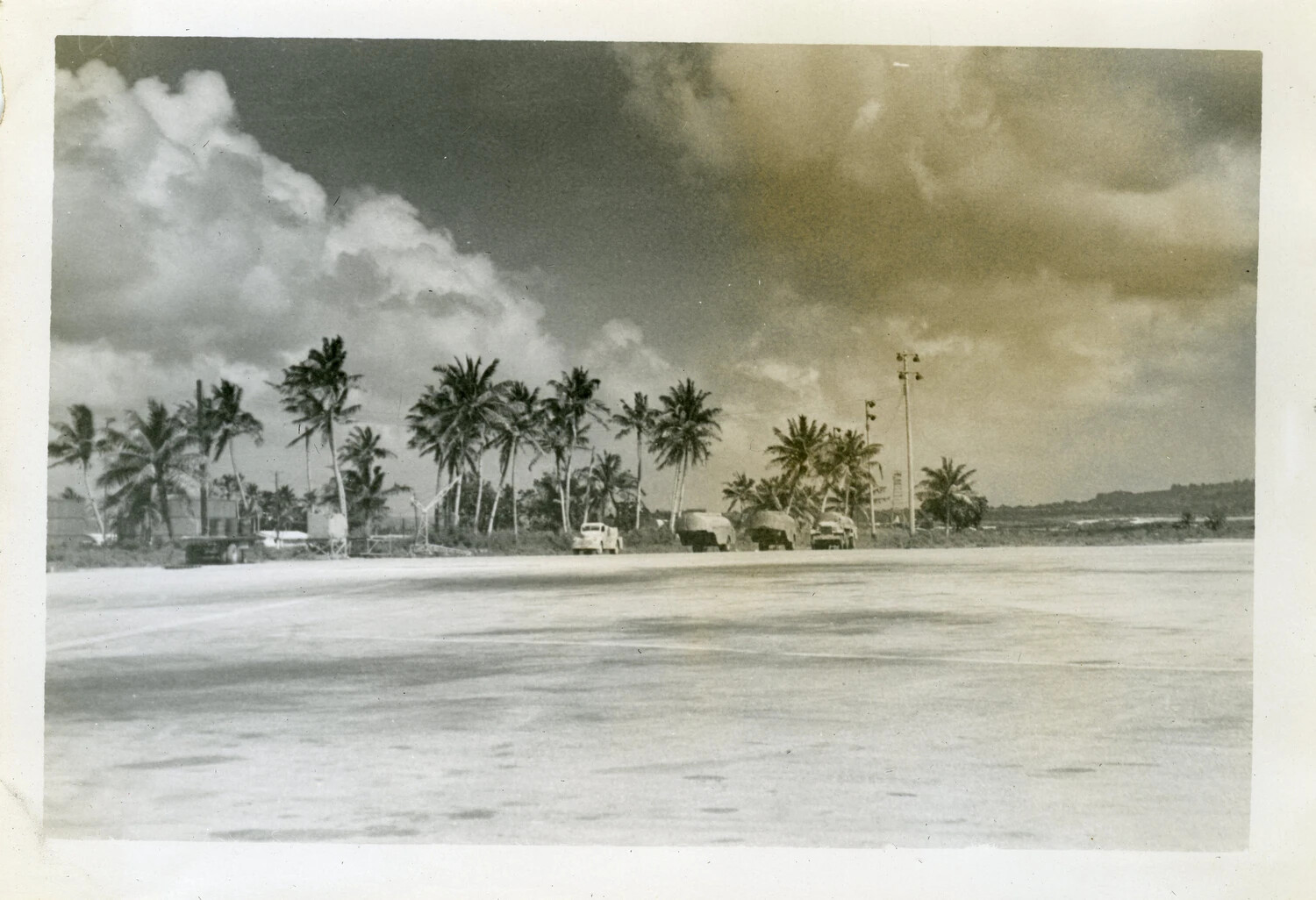 Airfield Ramp with Military Vehicles and Palm Tree Line, Naval Air Station Agana, Guam