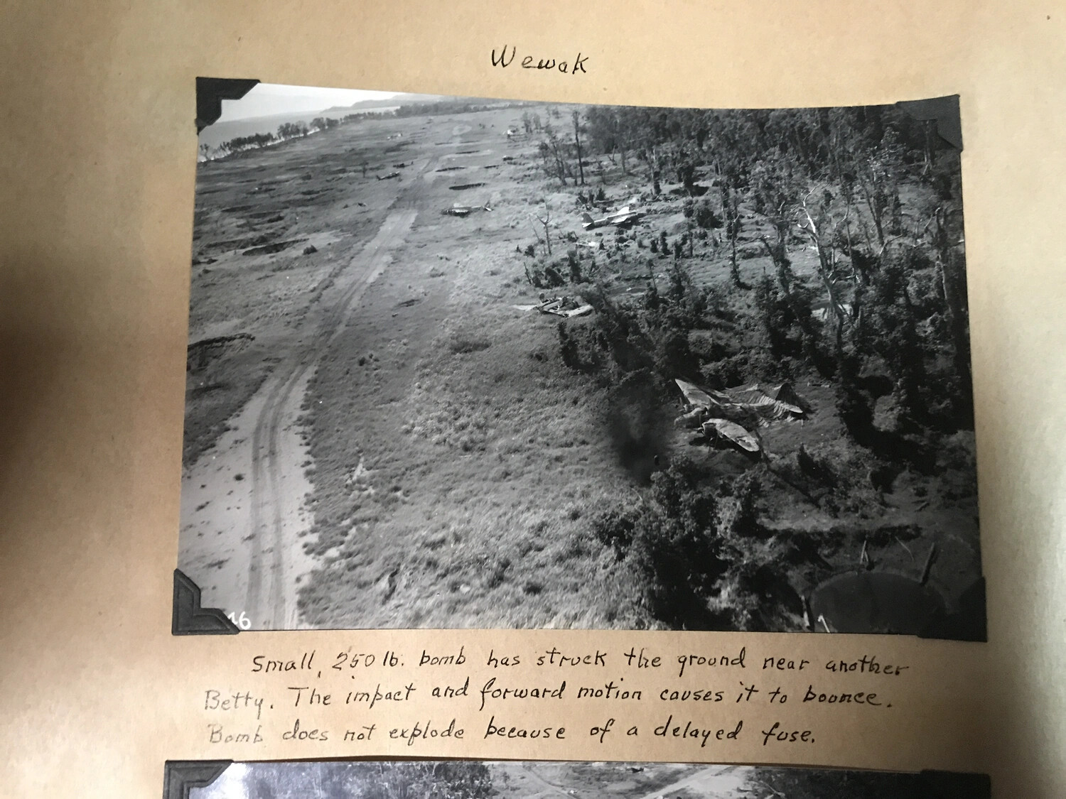 Album Page: 'Wewak' - Bombing Strike Photo with Delayed-Fuse Bomb Caption (Duplicate Scan)