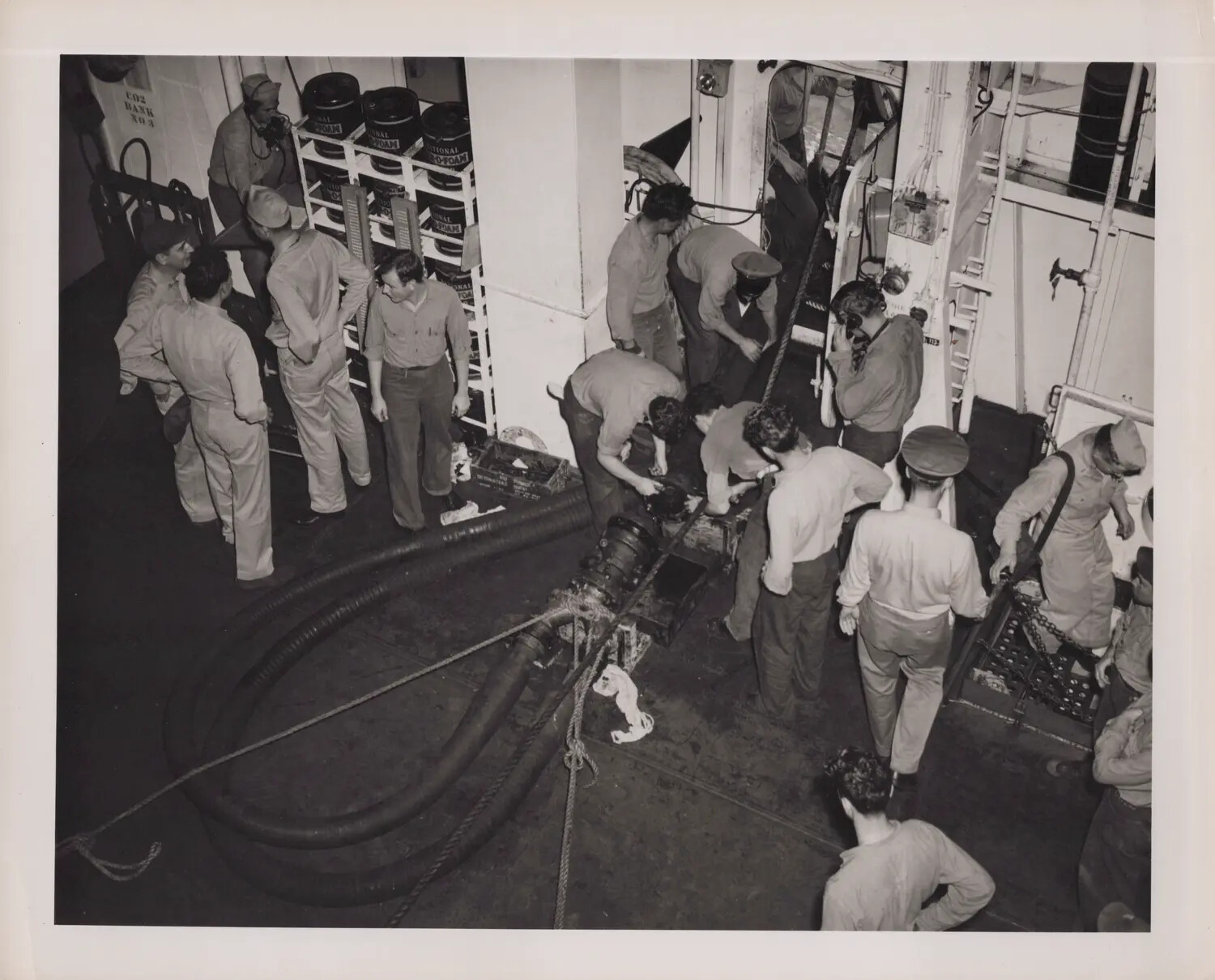 Sailors Servicing Fire-Fighting Hose Equipment on Hangar Deck, WWII Escort Carrier