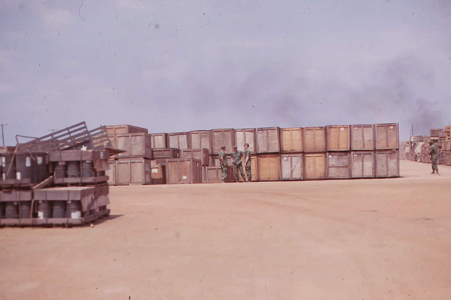 Supply Yard with Stacked Ordnance Crates and Servicemen, Vietnam, 1968 Tet Offensive Era