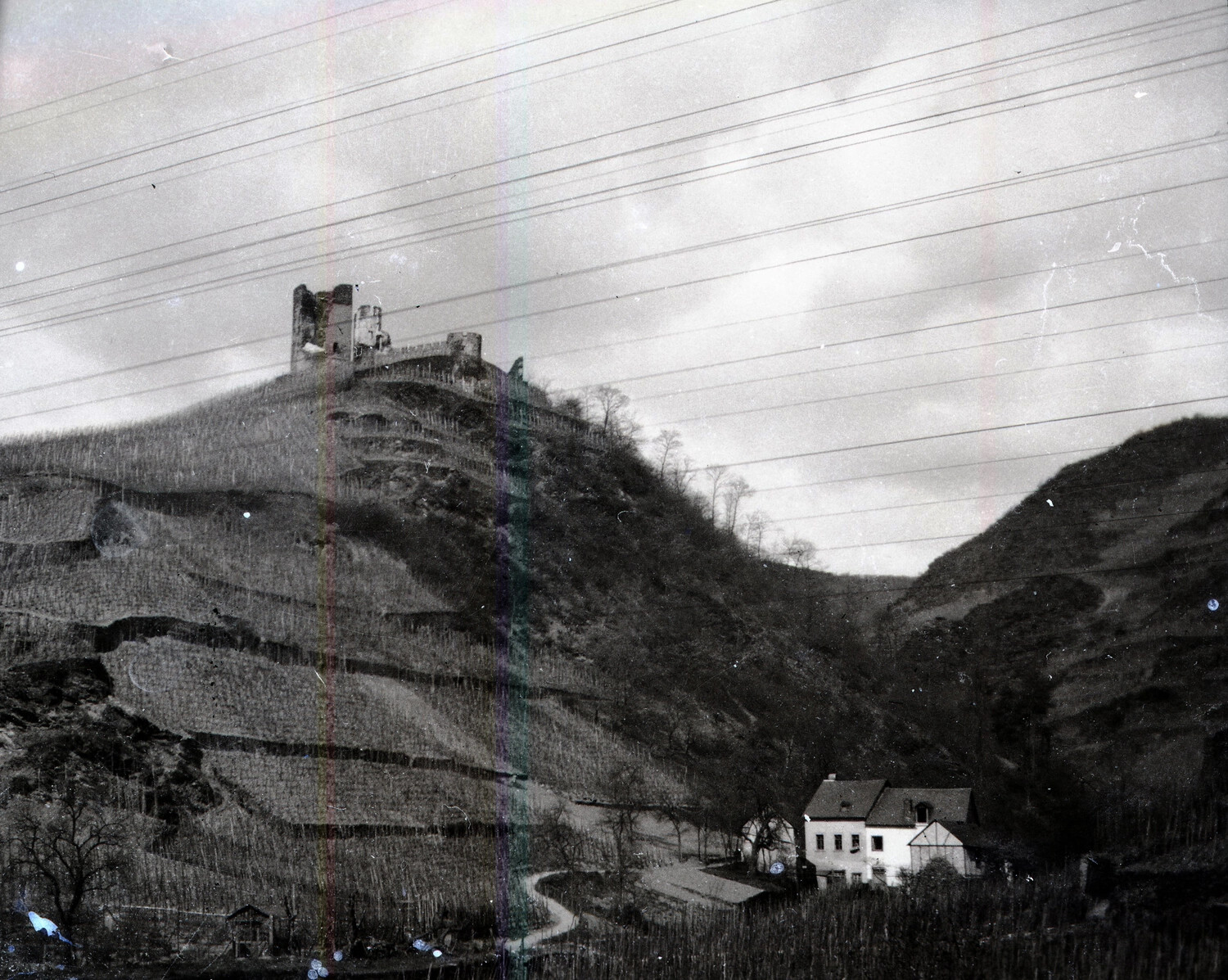 Ruined Hilltop Castle Overlooking Terraced Vineyard Valley, WWI Era