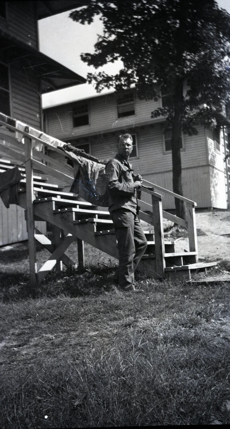 Serviceman on Barracks Stairway, Likely Stateside Training Camp, World War II Era