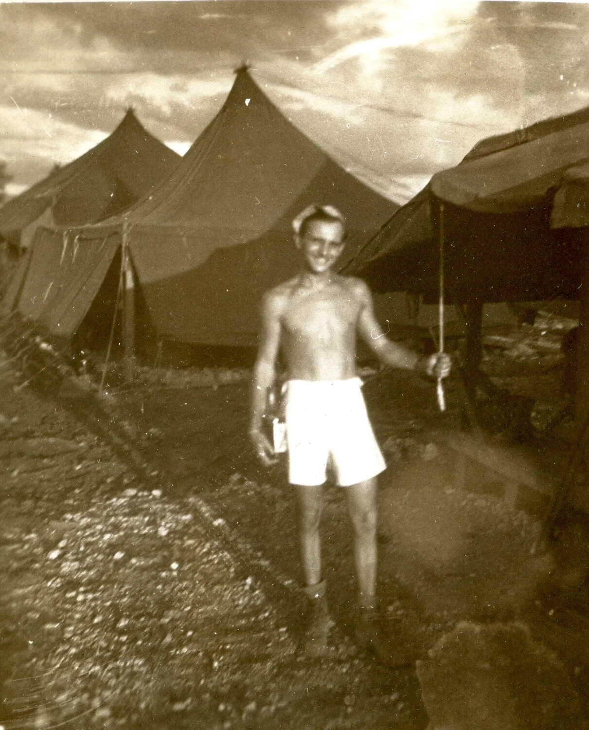 Serviceman in Camp Area with Pyramidal Tents — 345th Bombardment Group Encampment, Ie Shima, WWII