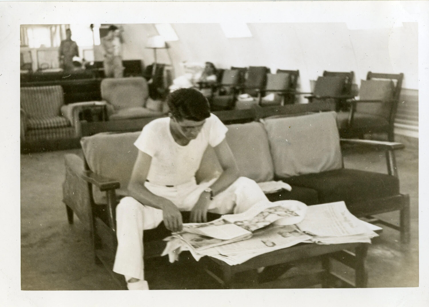 Sailor Reading Newspaper in Quonset Hut Day Room, VR-6, Agana, Guam
