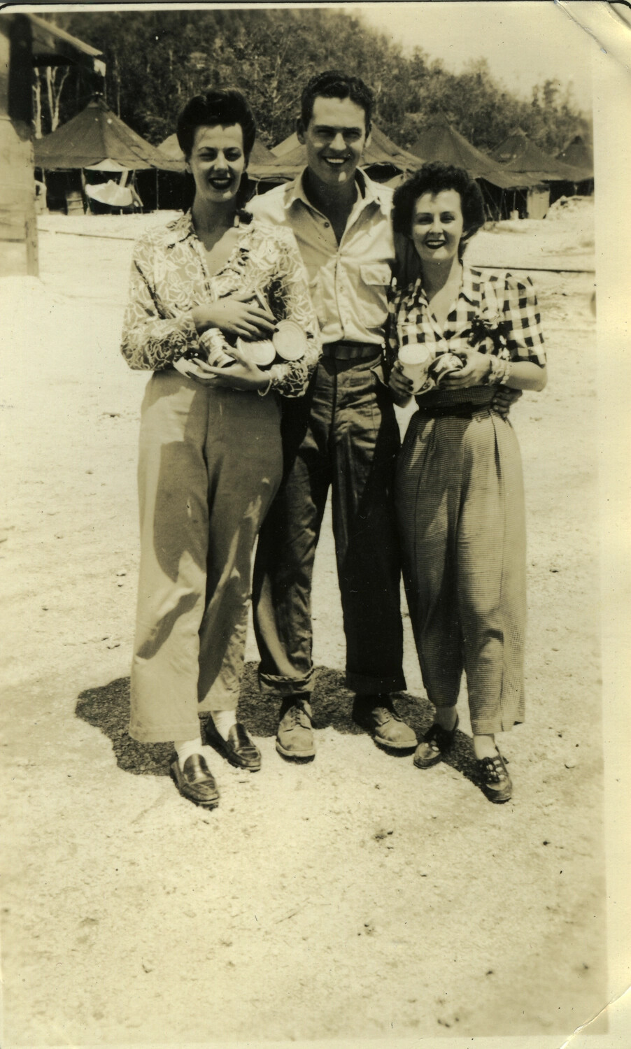 Serviceman with Two Women at Tent Encampment, Pacific Theater, WWII