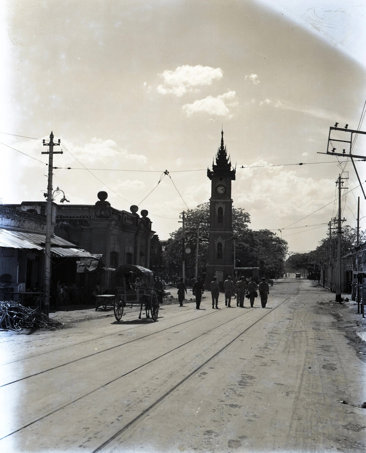 Street Scene with Clock Tower and Uniformed Personnel, Mandalay, Burma, WWII Era (CBI Theater)