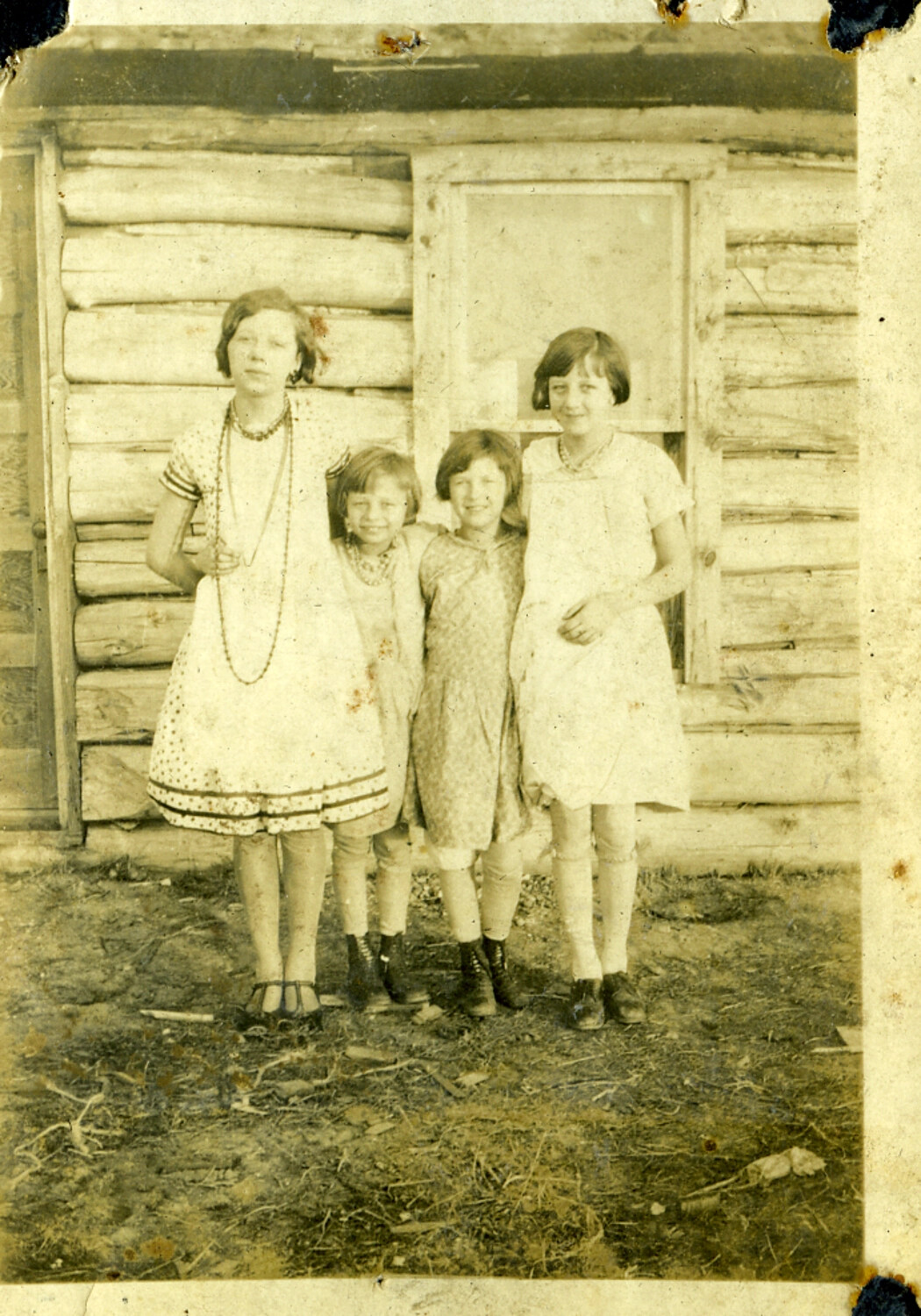 Four Girls in Front of a Log Cabin, Manila Photo Album