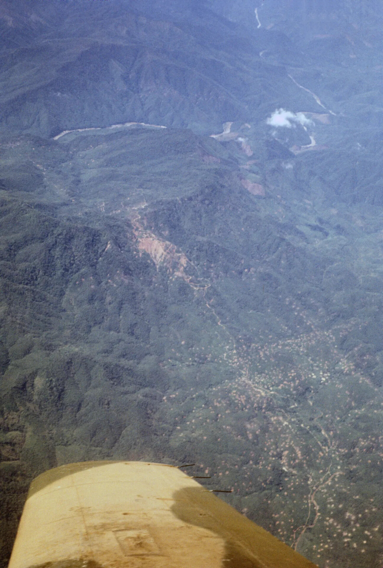 Aerial View of Mountainous Terrain and Valley Settlement, Southeast Asia, Vietnam War Era (Standard Resolution)