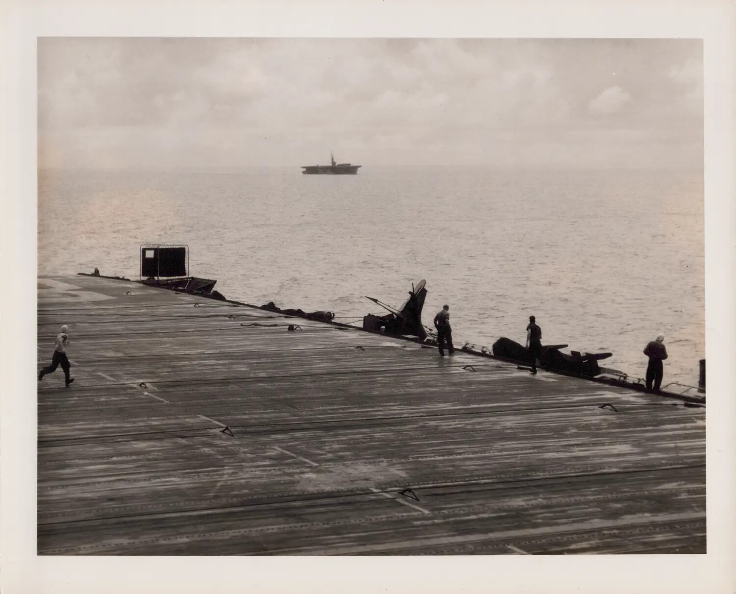 Wrecked Aircraft Remains Being Jettisoned from Escort Carrier Flight Deck, WWII