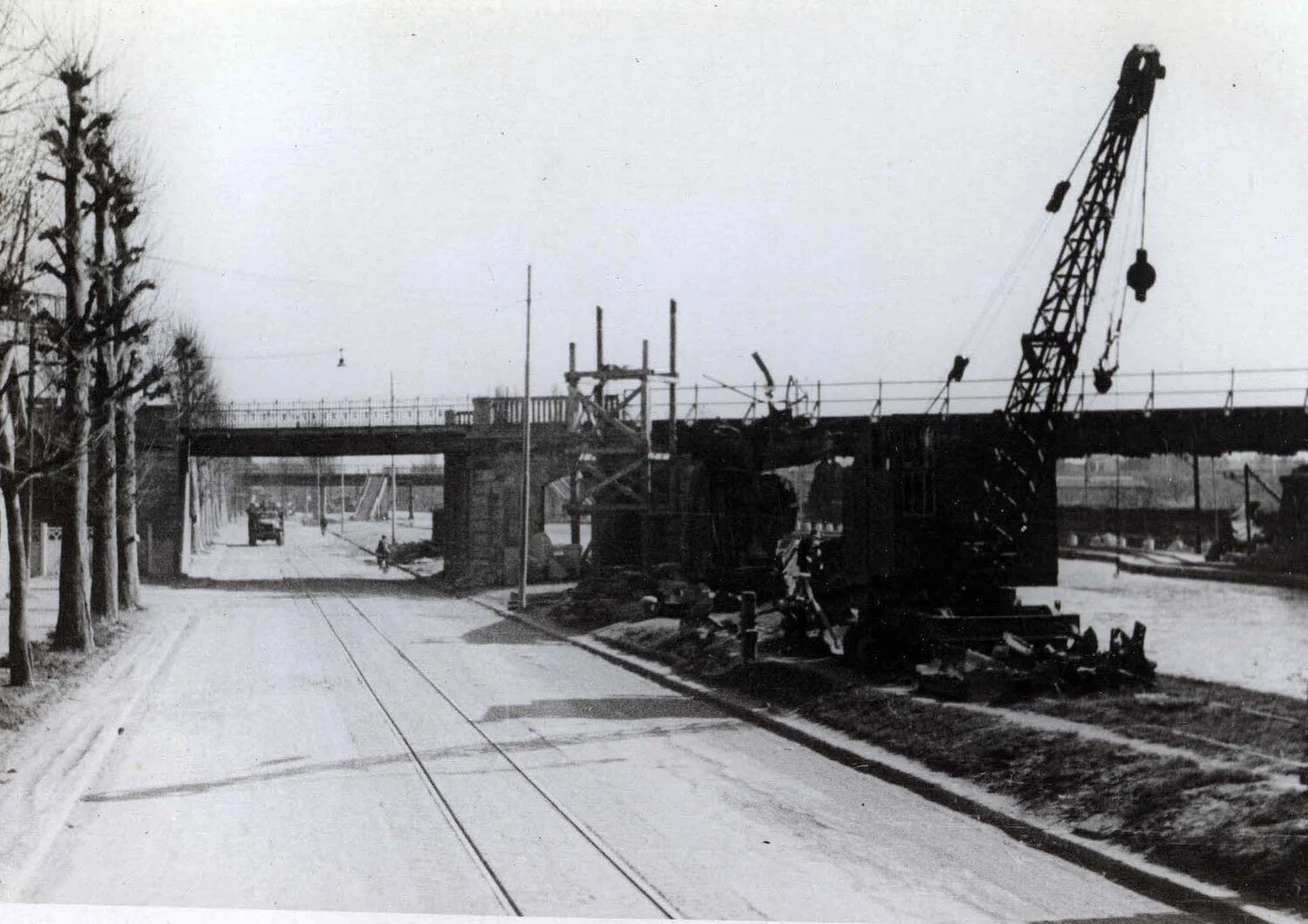 War-Damaged Railway Bridge Under Repair with Mobile Crane, European City Street, WWII