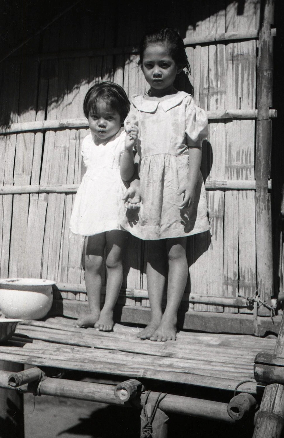 Two Filipino Children on a Bamboo Porch, Luzon, Philippines, WWII Era