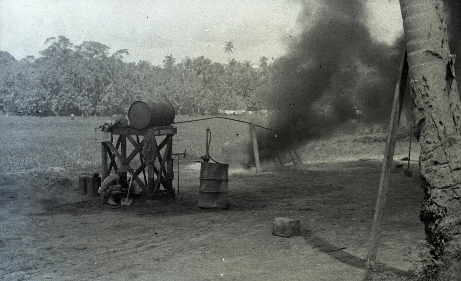 Fuel Drum Refueling Station with Smoke Plume, Luzon, Philippines, WWII