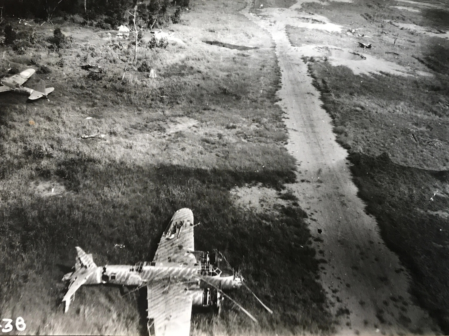 Wrecked Japanese Aircraft Beside Airfield Taxiway, New Guinea Strike Damage