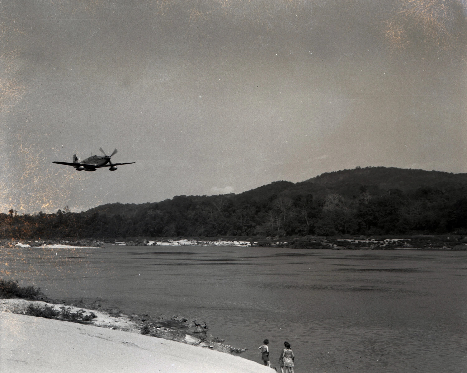 Low-Flying Fighter Aircraft over River with Onlookers on Riverbank, CBI Theater, WWII, Kotec Burma Collection